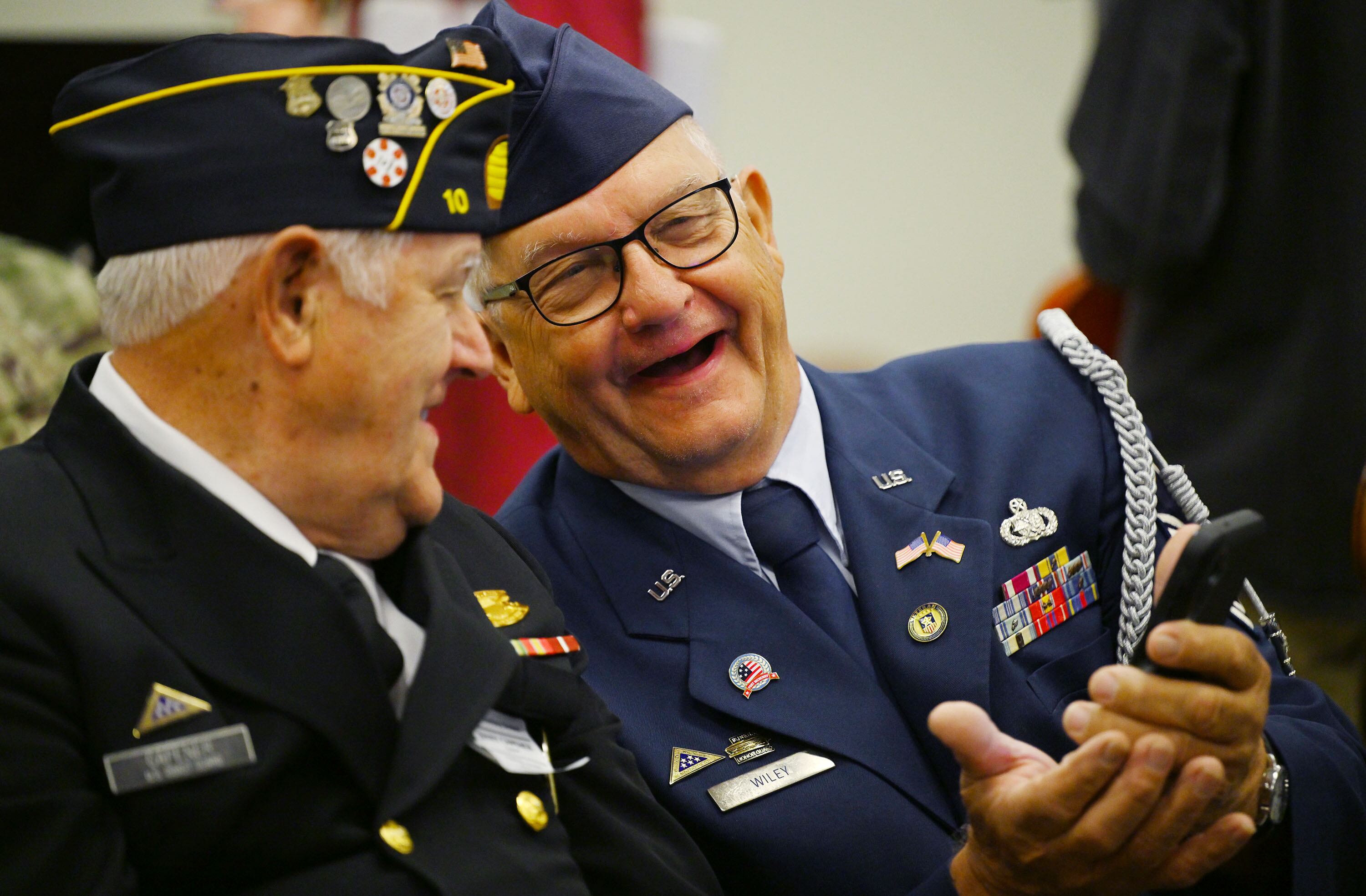 Jerry Capener, U.S. Coast Guard retired, and Rew Wiley, U.S. Air Force, laugh as they talk while joining Utah Rep. Blake Moore and Jennie Taylor, the Gold Star widow of Utah Army National Guard Maj. Brent Taylor, who was killed in action in Afghanistan in November of 2018, and students at Promontory School of Expeditionary Learning to honor local service members at an assembly in Perry on Monday.