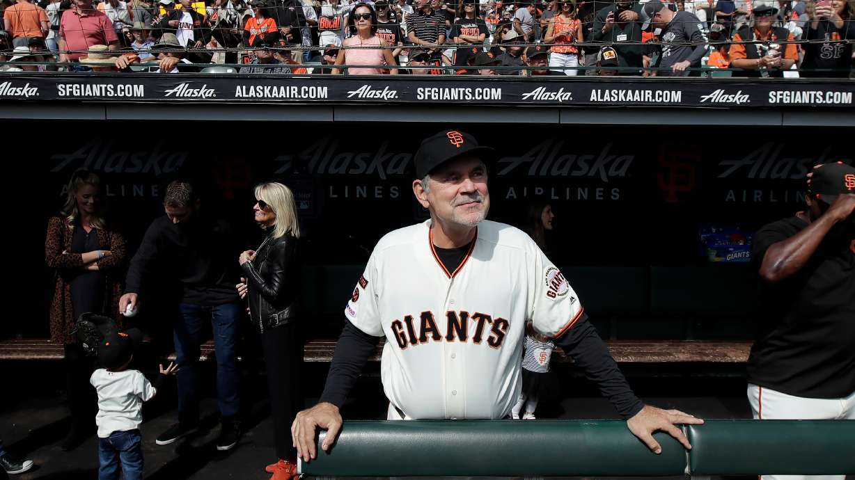 FILE - San Francisco Giants manager Bruce Bochy stands in the dugout before a baseball game between the Giants and the Los Angeles Dodgers in San Francisco, Sept. 29, 2019.