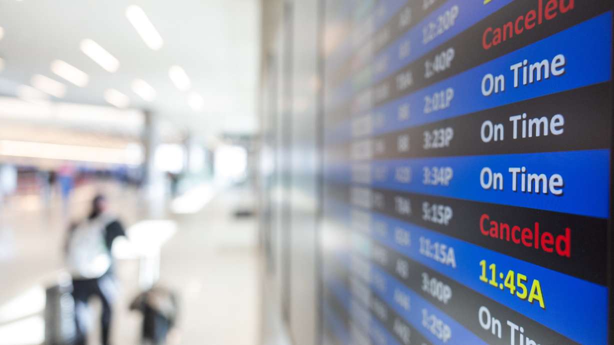 The departure and arrival boards at Salt Lake City International Airport display some of the canceled flights due to the federal government shutdown on Monday. Thousands of flights were canceled over the weekend, and the cancellations will continue this week.
