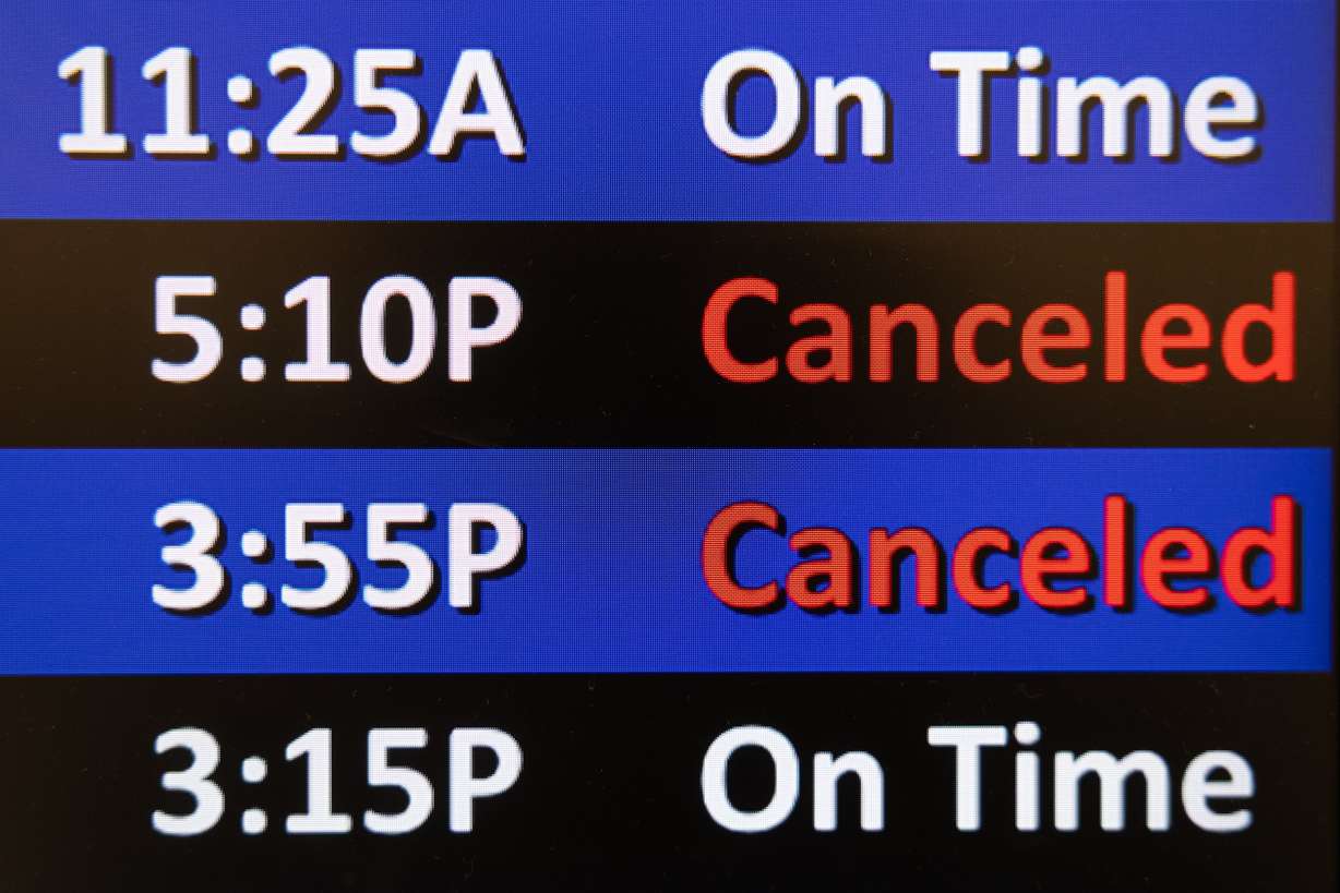 The departure and arrival boards at Salt Lake City International Airport display some of the canceled flights due to the federal government shutdown on Monday.