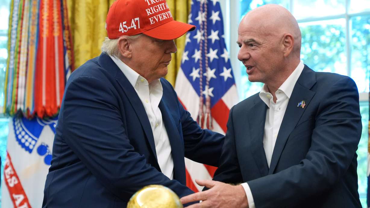 President Donald Trump, left, shakes the hand of FIFA President Gianni Infantino at the conclusion of an announcement in the Oval Office of the White House, Aug. 22, in Washington.