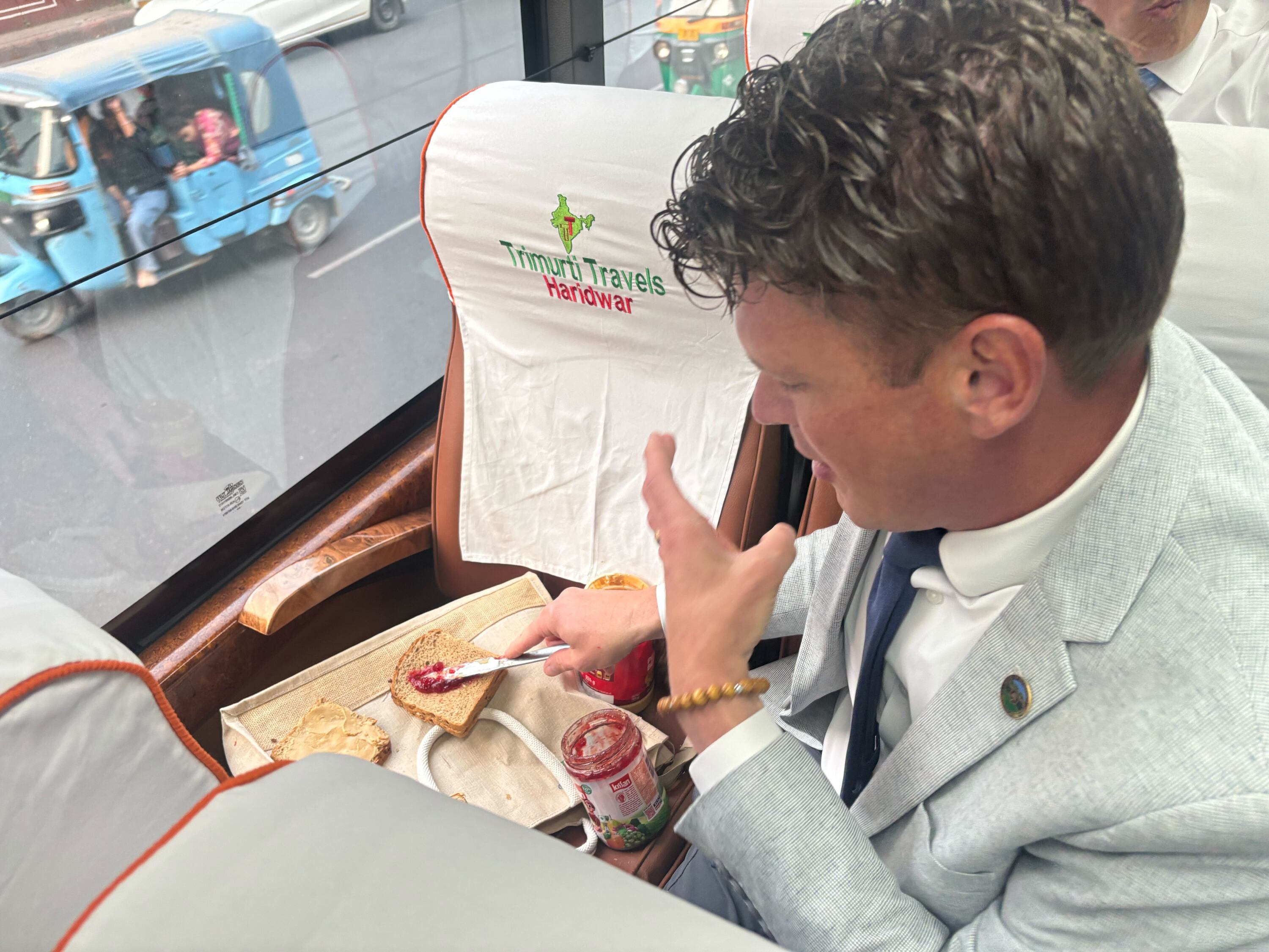 Utah Rep. Jason Thompson, R-River Heights, making peanut butter and jelly sandwiches on the bus in between ministry meetings in New Delhi.