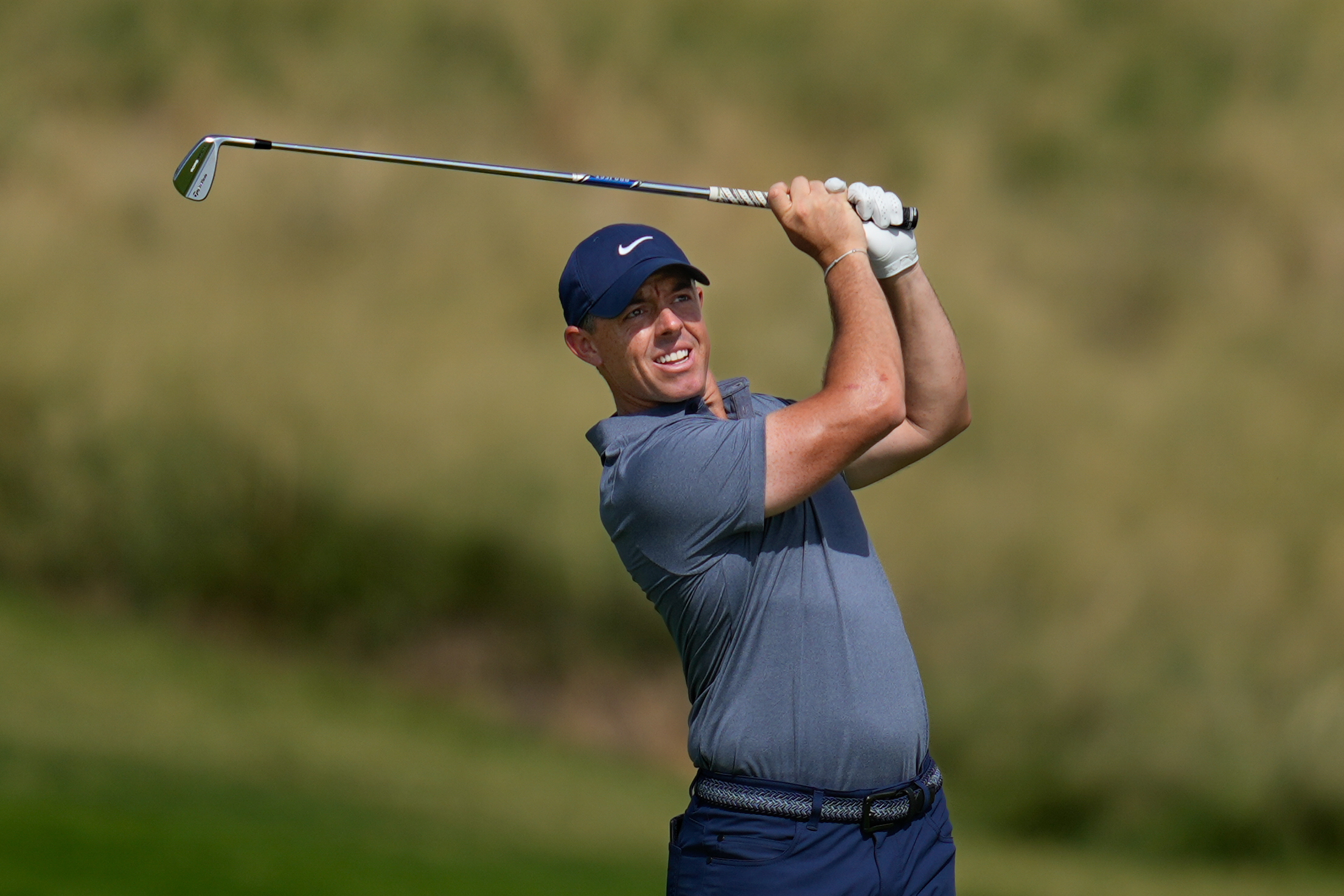 Rory McIlroy of Northern Ireland watches after playing second shot on the 7th hole during the final round of Abu Dhabi Golf Championship in Abu Dhabi, United Arab Emirates, Sunday, Nov. 9, 2025.