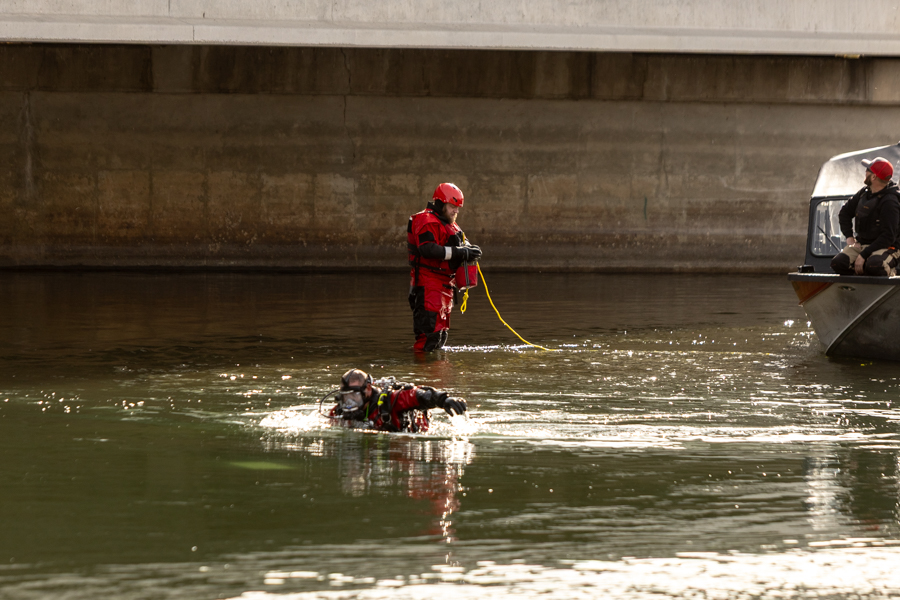 Divers in the water attempt to recover pieces of a small passenger plane from the Snake River on Monday. The plane crashed on Sunday.