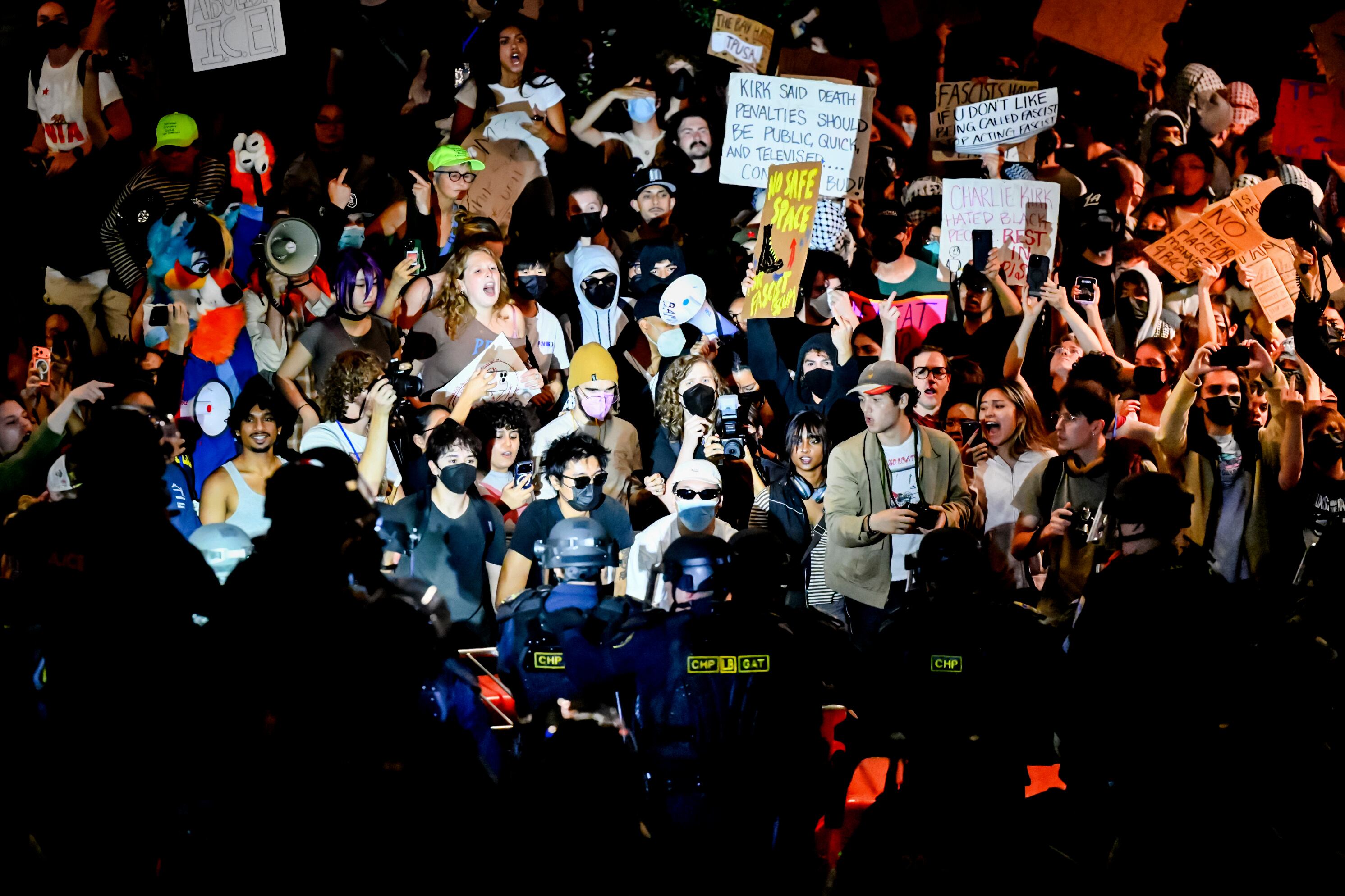 Protesters face off against police outside a "This Is the Turning Point" campus tour event at the University of California, Berkeley, in Berkeley, Calif., Monday. Four students, all women, were arrested during a clash with police.
