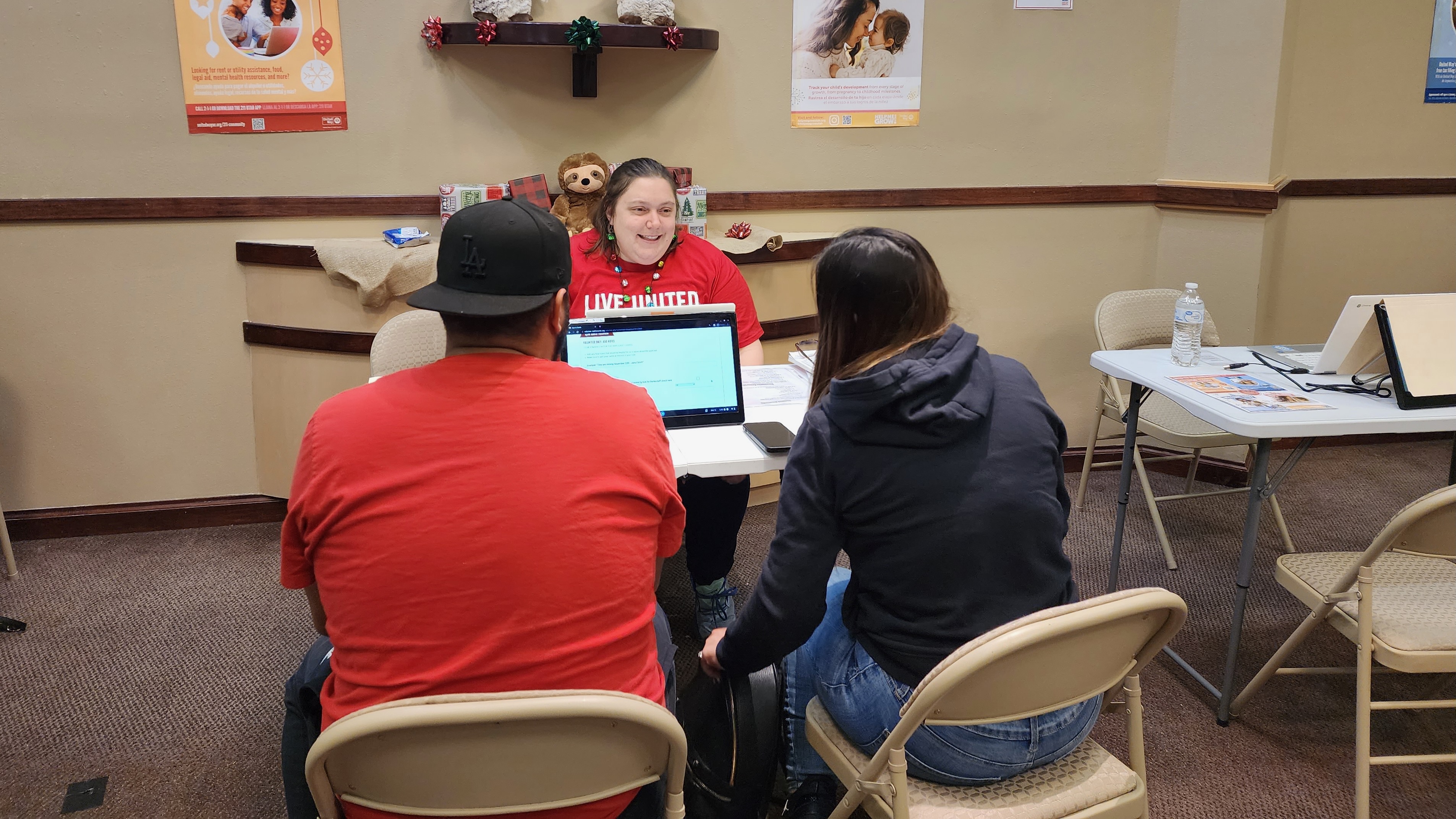 United Way of Utah County seeks Spanish speakers to help with its annual Sub for Santa Christmas initiative geared to kids and families in need. The photo from 2022 shows a United Way representative working with a couple interested in the program.