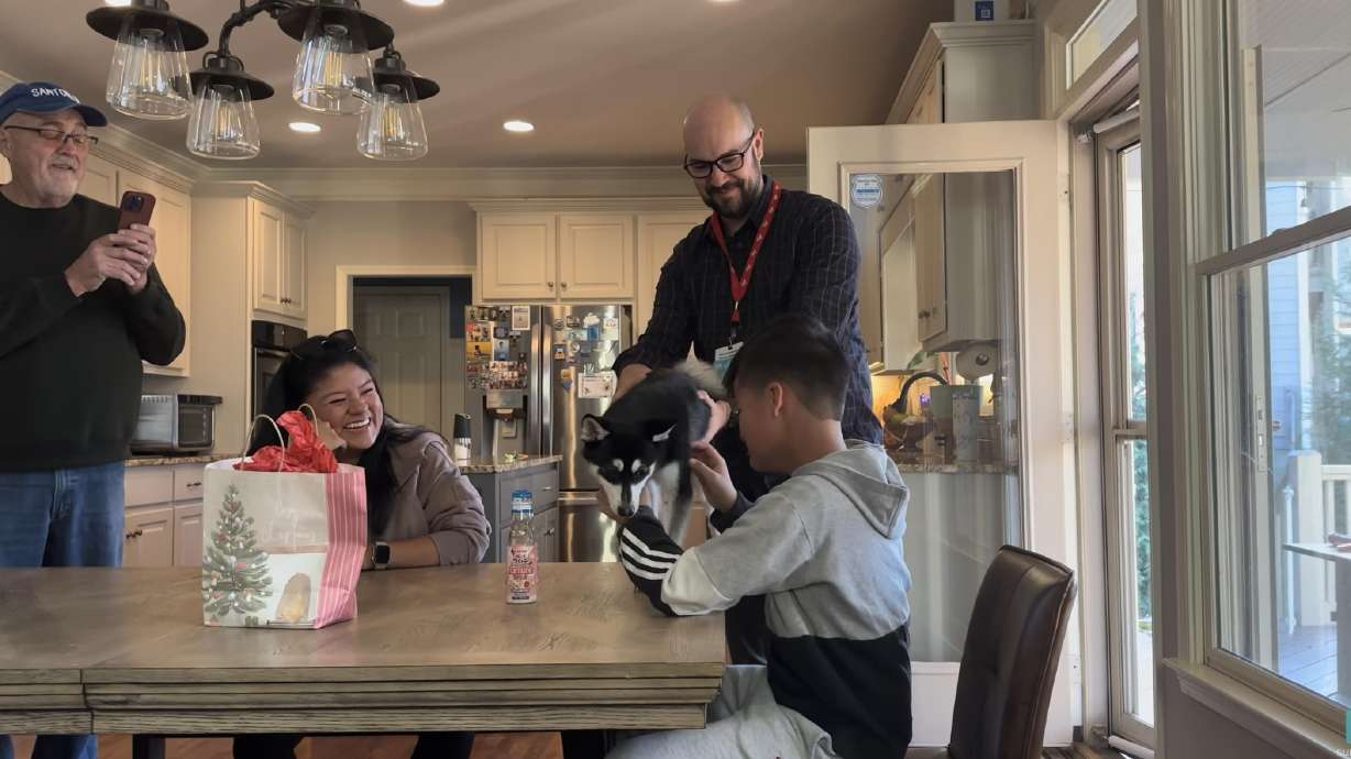 Leida Andersen's 13-year-old son reacts to a puppy as a present on Christmas Eve 2024. The family lost a prior dog to old age not long before.