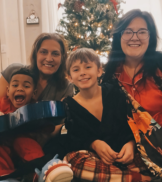 Carter Grover (left) with his grandmother, Laurie Peterson, brother William Grover, and mother, Katherine Grover. The family has been facing challenges since Carter was severely injured in a car crash on Sept. 22.