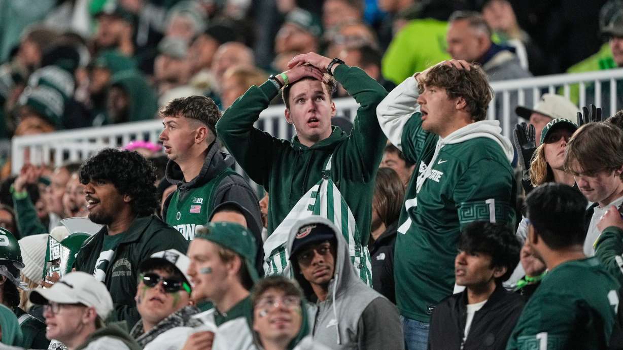 Michigan State fans react during the first half of an NCAA college football game against Michigan Saturday, Oct. 25, 2025, in East Lansing, Mich.