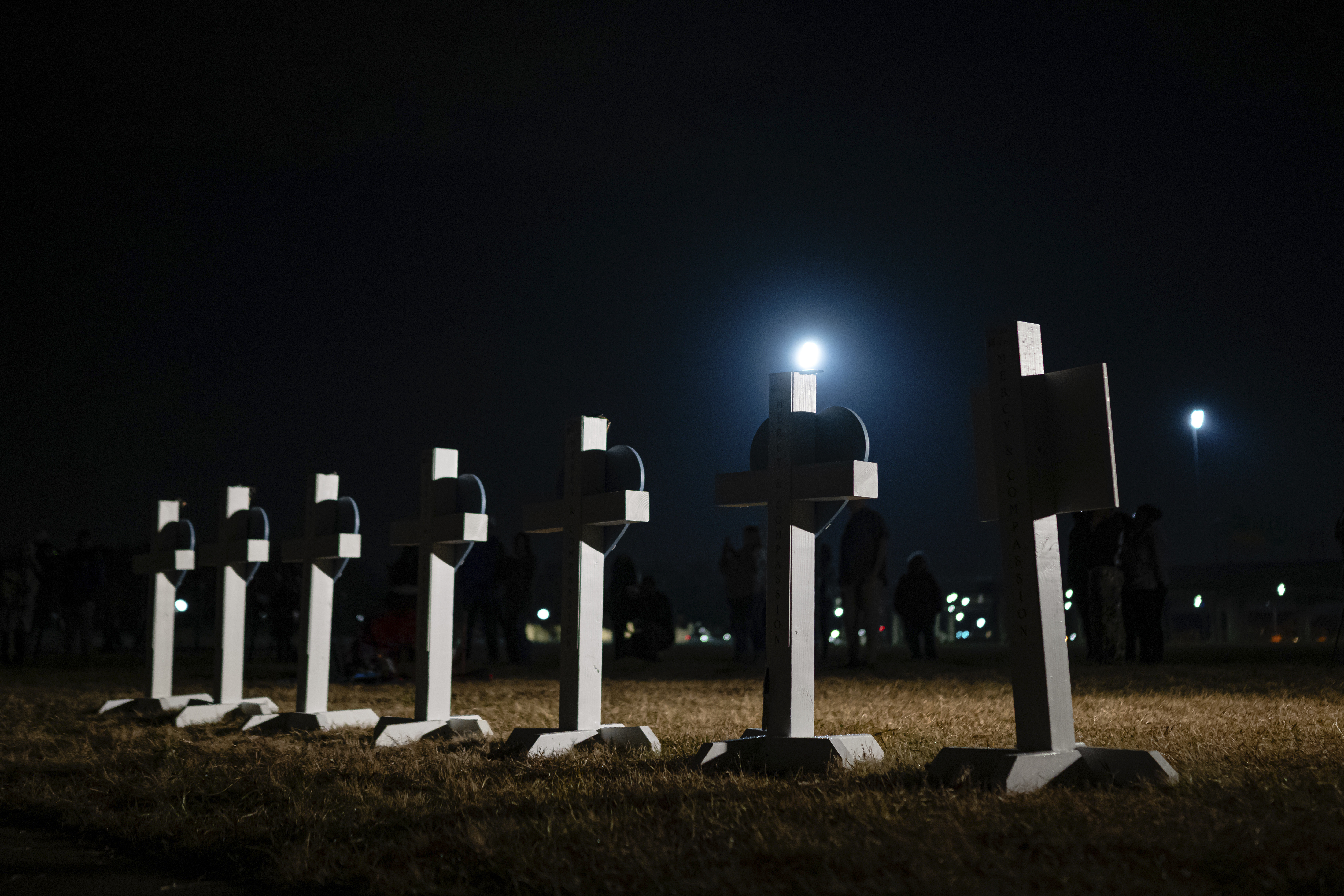 Crosses stand during a vigil for those killed and missing after a UPS plane crashed, at the Great Lawn, Friday, in Louisville, Ky. All 14 victims in the crash were identified on Wednesday.