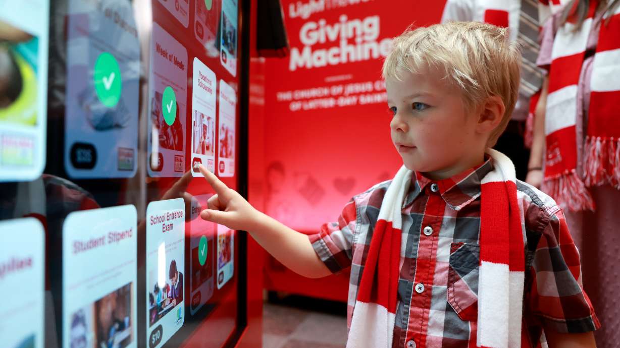 Walker Whiting, 4, tests out a demonstration version of a digital 2025 Light the World Giving Machine during the Giving Machine initiative’s launch at the Conference Center on Nov. 12, 2025.
