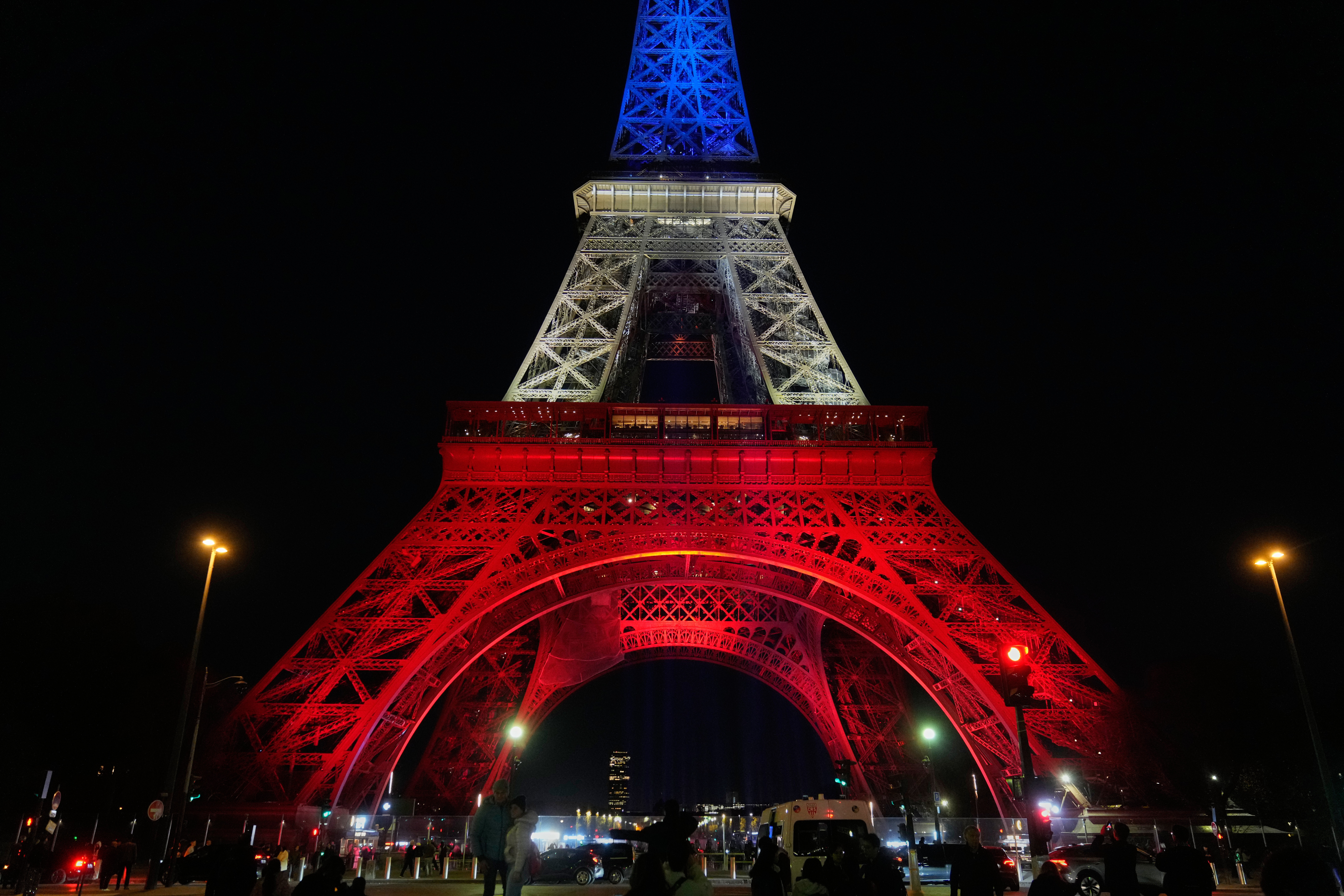 The Eiffel Tower is lit in the colors of the French national flag in Paris, Wednesday, to honor the victims of the terror attacks at the Bataclan concert hall, cafes, and the national stadium 10 years ago.