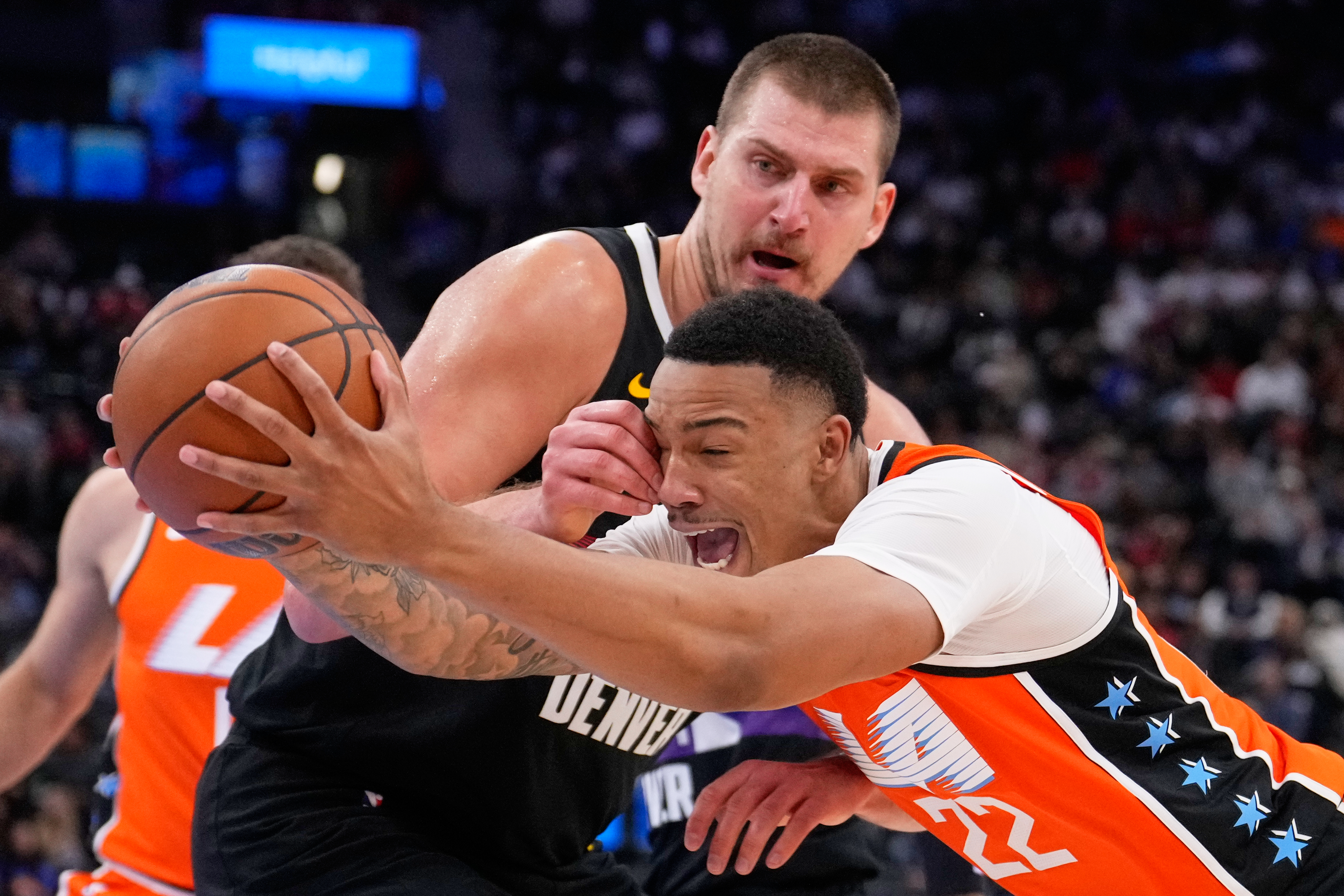 Los Angeles Clippers guard Jordan Miller, right, drives past Denver Nuggets center Nikola Jokic during the second half of an NBA basketball game Wednesday, Nov. 12, 2025, in Inglewood, Calif.