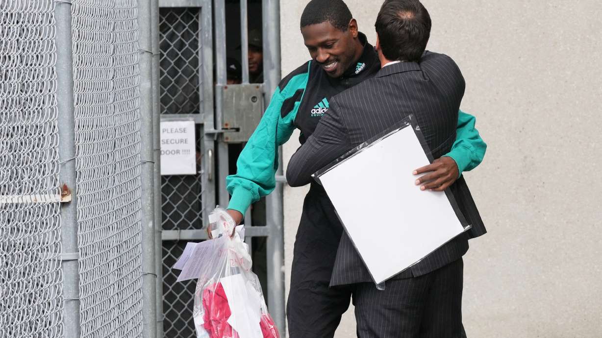 Former NFL star wide receiver Antonio Brown, left, greets his attorney Mark Russell Eiglarsh, right, after being released from the Turner Guilford Knight Correctional Center, Thursday, Nov. 13, 2025, in Miami.