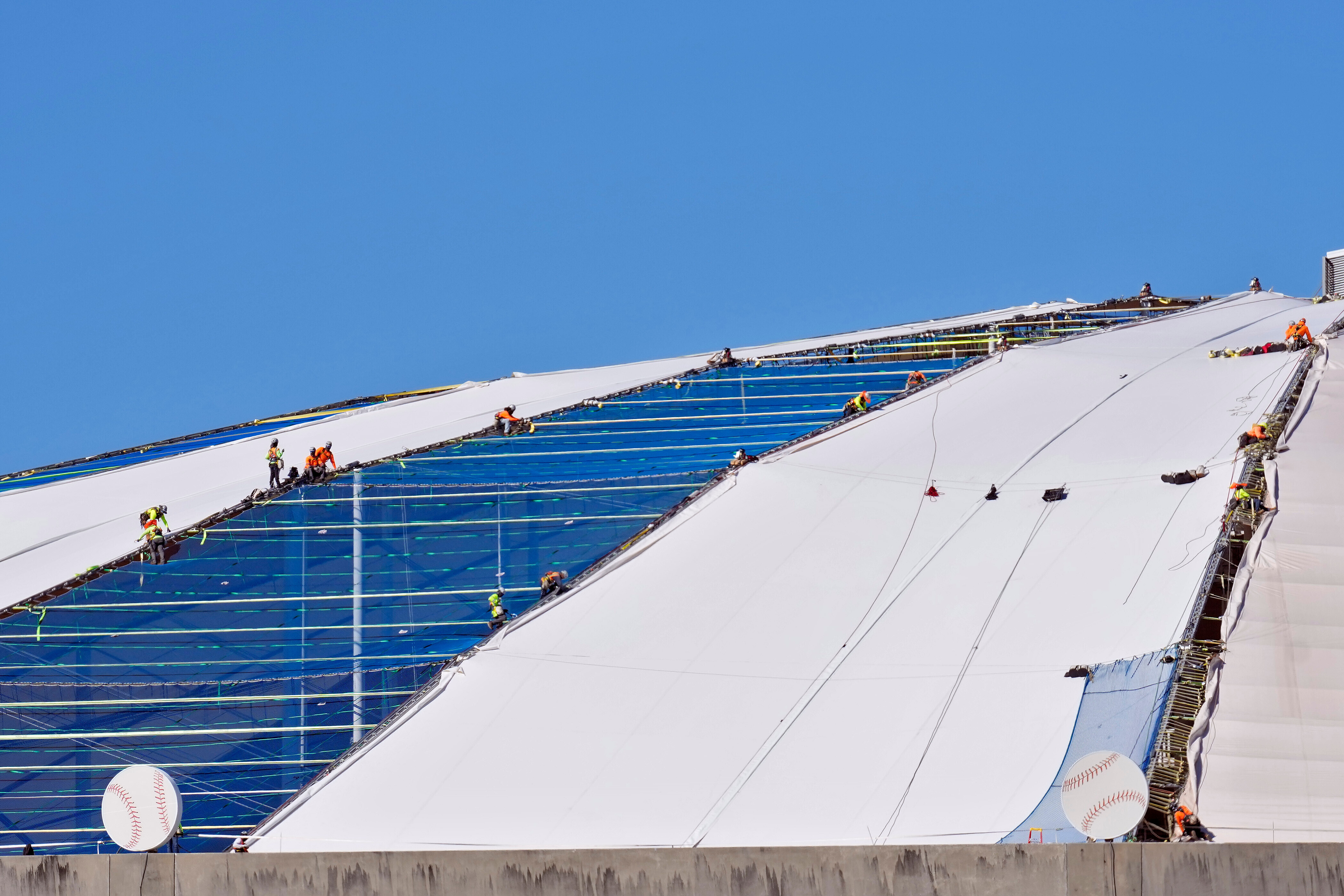 Workers continue to repair the panels on the roof of Tropicana Field Monday, Nov. 3, 2025, in St. Petersburg, Fla. The roof was destroyed by Hurricane Milton in 2024.