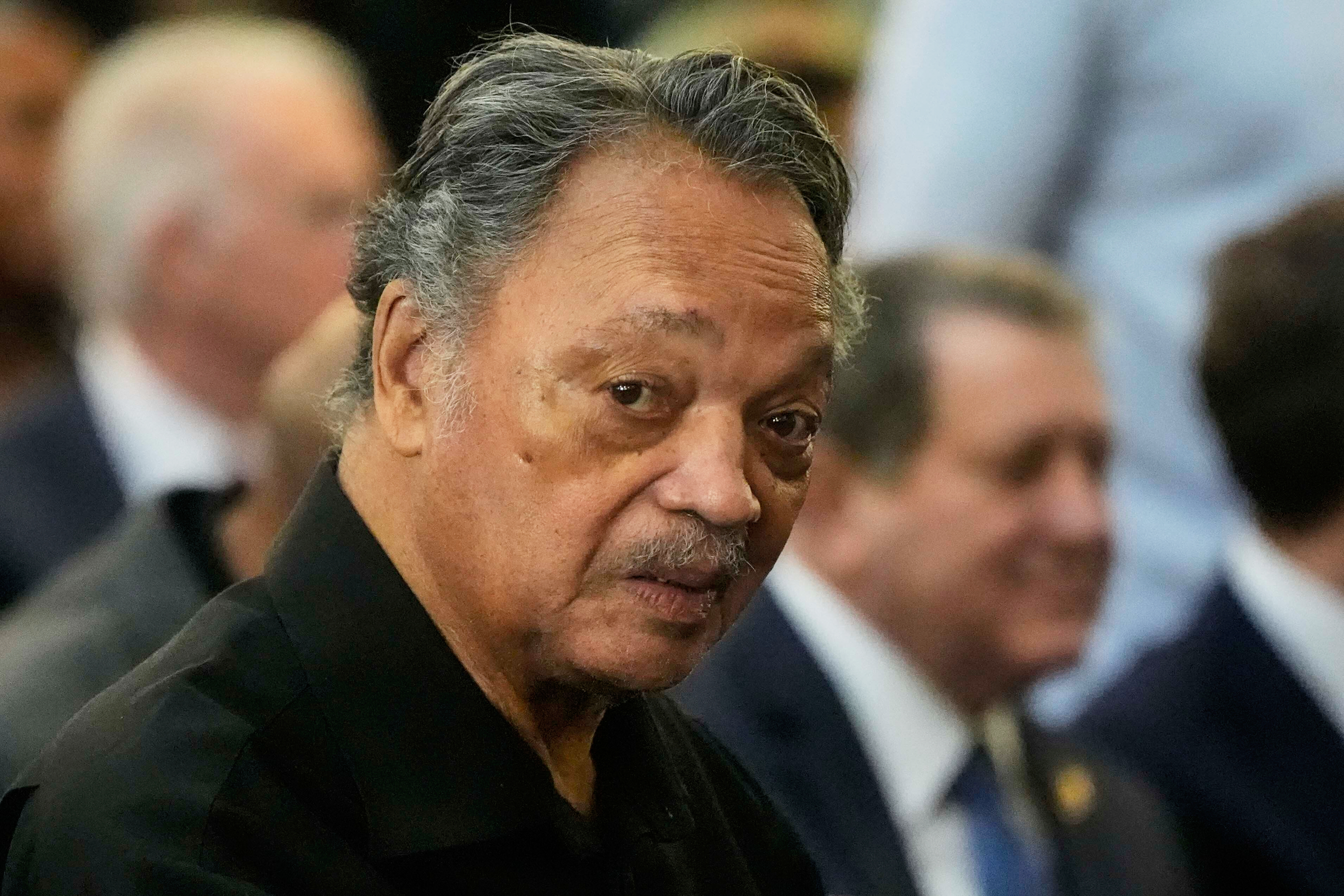 The Rev. Jesse Jackson listens to speakers at the Tabernacle Baptist Church, March 9, in Selma, Ala. Jackson's organization said he was hospitalized with a rare neurological disorder on Thursday.