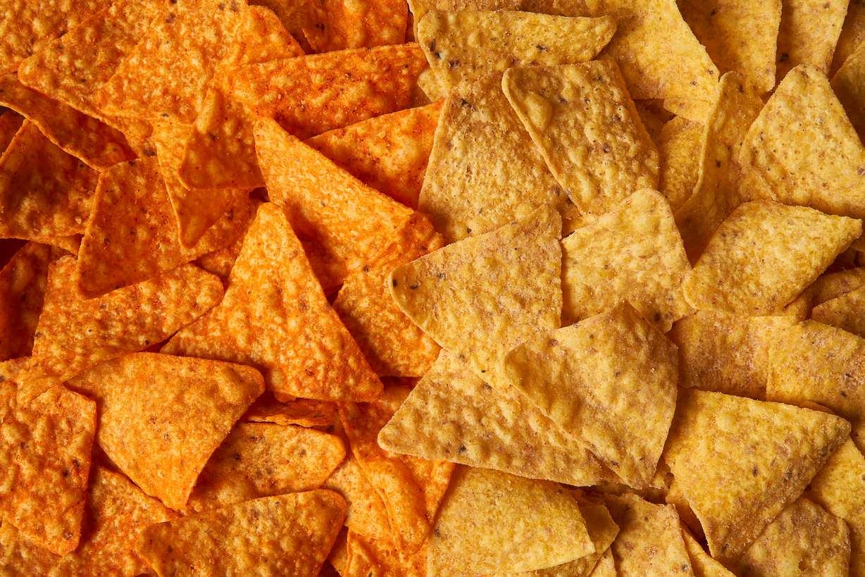 Original Doritos Nacho cheese chips next to new Doritos without artificial colors or flavors. The company on Thursday announced price hikes on snacks like Doritos after a weak performance in the third quarter.