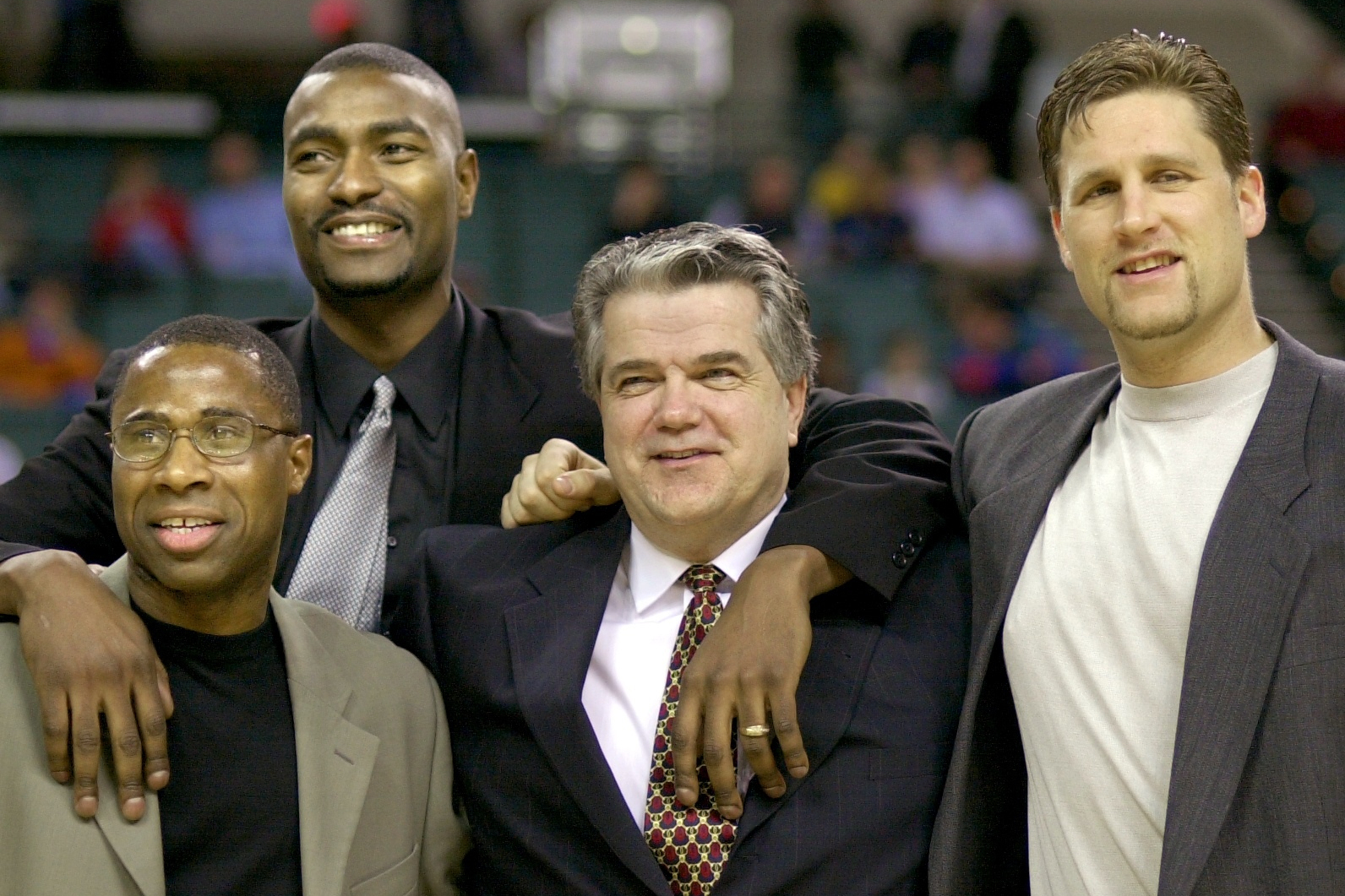 FILE - Members of the 1986 Cleveland State University men's basketball team, from left, Shawn Hood, Eric Mudd, coach Kevin Mackey, and Pat Vuyanich are honored during halftime of an NCAA college basketball game, Jan. 20, 2001, in Cleveland.