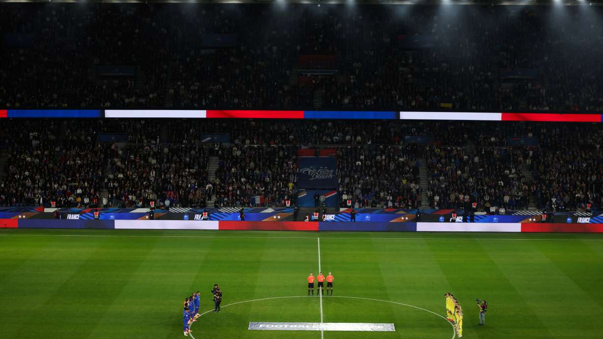 Ukrainian, right, and French players observe a minute of silence in tribute to the victims of the Nov.13, 2015 Paris attacks, ahead of the 2026 World Cup qualifiers Europe zone group D football match between France and Ukraine at the Parc des Princes stadium, Thursday, Nov. 13, 2025 in Paris.