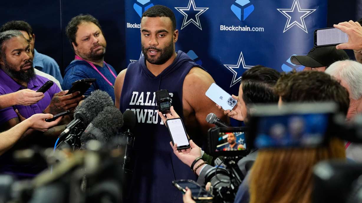 CORRECTS TO THURSDAY, NOV. 13 NOT FRIDAY, NOV. 14 - Dallas Cowboys' Solomon Thomas, center, responds to a question during a news conference after an NFL football practice at the team's headquarters Thursday, Nov. 13, 2025, in Frisco, Texas.