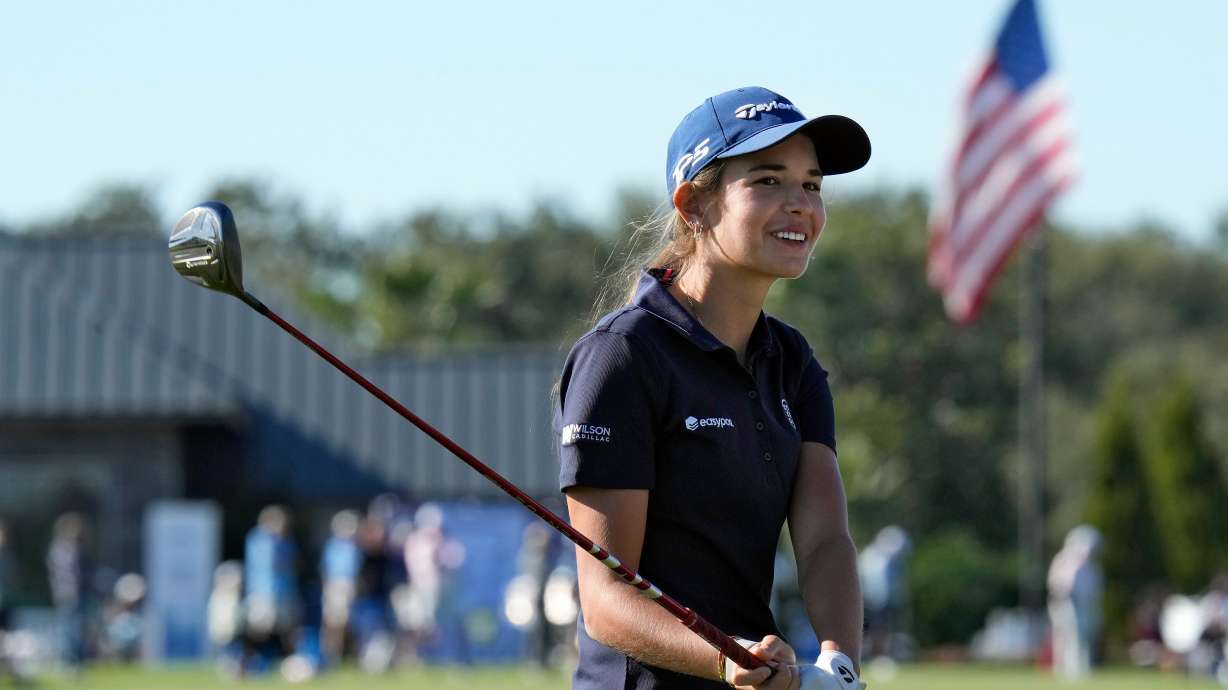 Kai Trump, granddaughter of President Donald Trump, smiles as she waits to hit from the 18th fairway during the first round of The Annika LPGA golf tournament Thursday, Nov. 13, 2025, in Belleair, Fla.