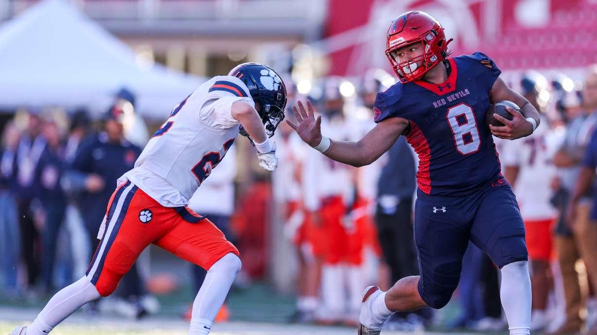Springville’s Tua Naufahu (8) stiff arms Brighton’s Owen Hanson (22) in the 5A football semifinal game at Rice-Eccles Stadium in Salt Lake City on Thursday, Nov. 13, 2025.