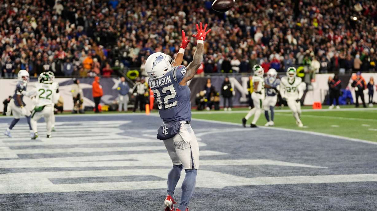 New England Patriots running back TreVeyon Henderson catches a touchdown pass during the second half of an NFL football game against the New York Jets, Thursday, Nov. 13, 2025, in Foxborough, Mass.