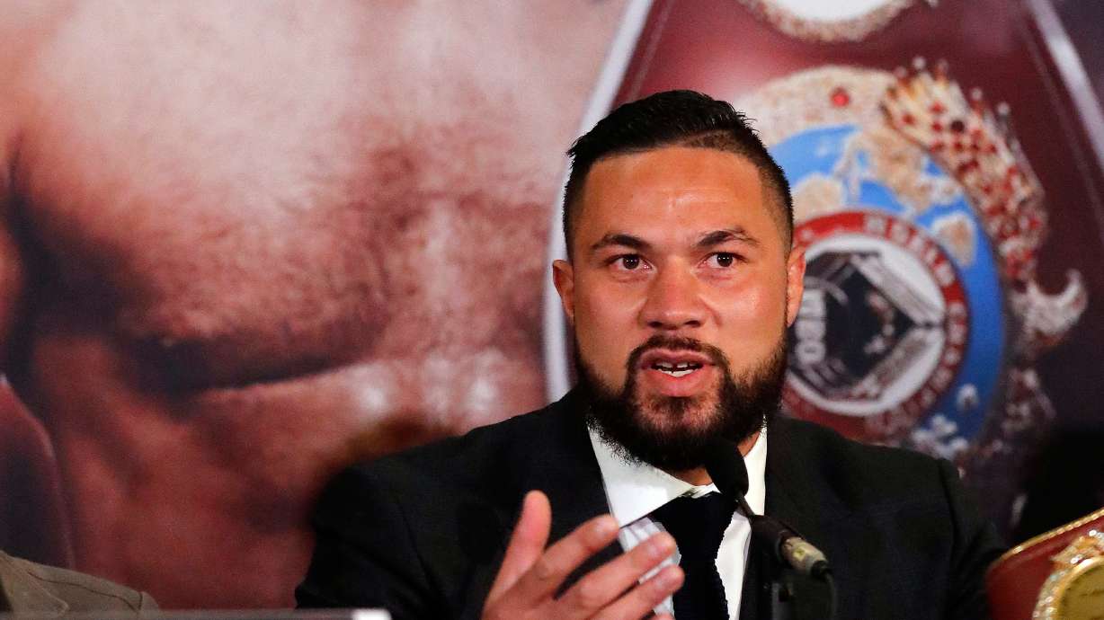 FILE - New Zealand's Joseph Parker speaks in front of his picture during a media conference with World Heavyweight boxer Anthony Joshua of Britain in London, Tuesday, Jan. 16, 2018.