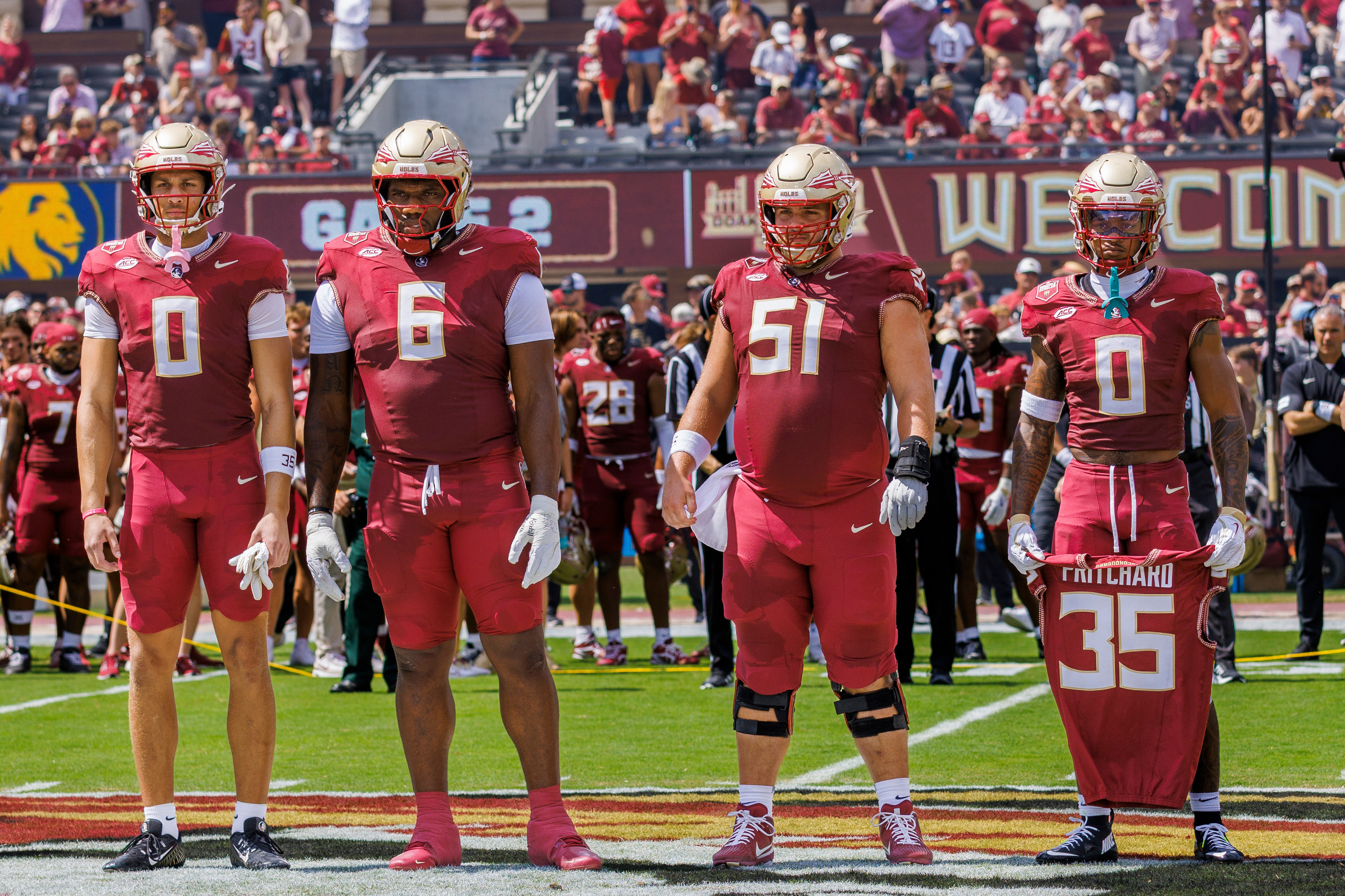 FILE - Florida State defensive back Earl Little Jr. (0) right, holds the jersey of linebacker Ethan Pritchard (35), as he is joined by Duce Robinson (0), Darrell Jackson Jr. (6), and Luke Petitbon (51) before the start of an NCAA college football game against East Texas A&M, Sept. 6, 2025, in Tallahassee, Fla.