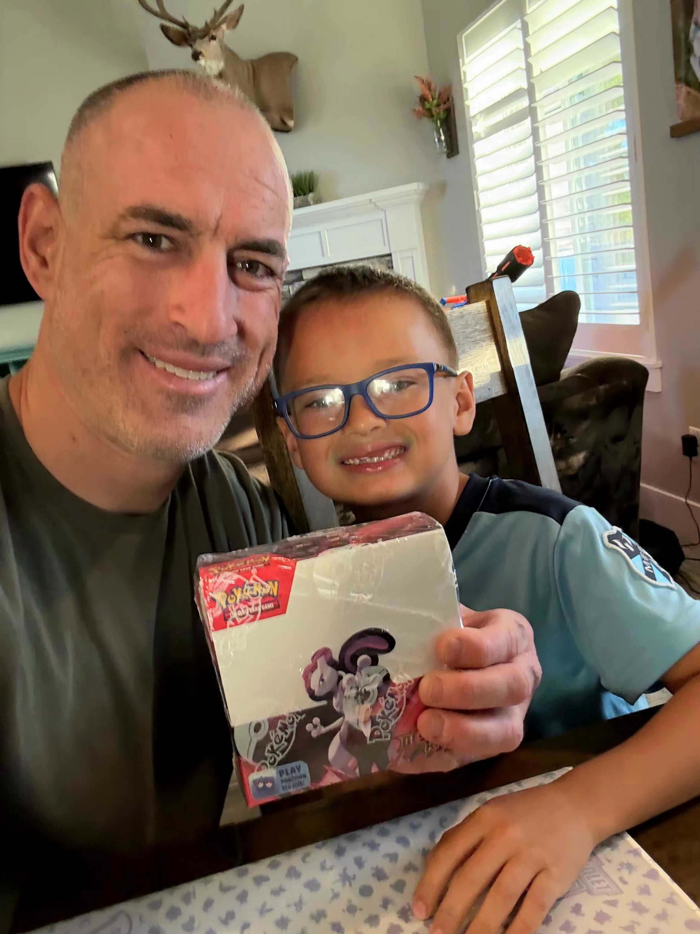 Michael Vickers and his son share their excitement over their latest Pokémon card find.