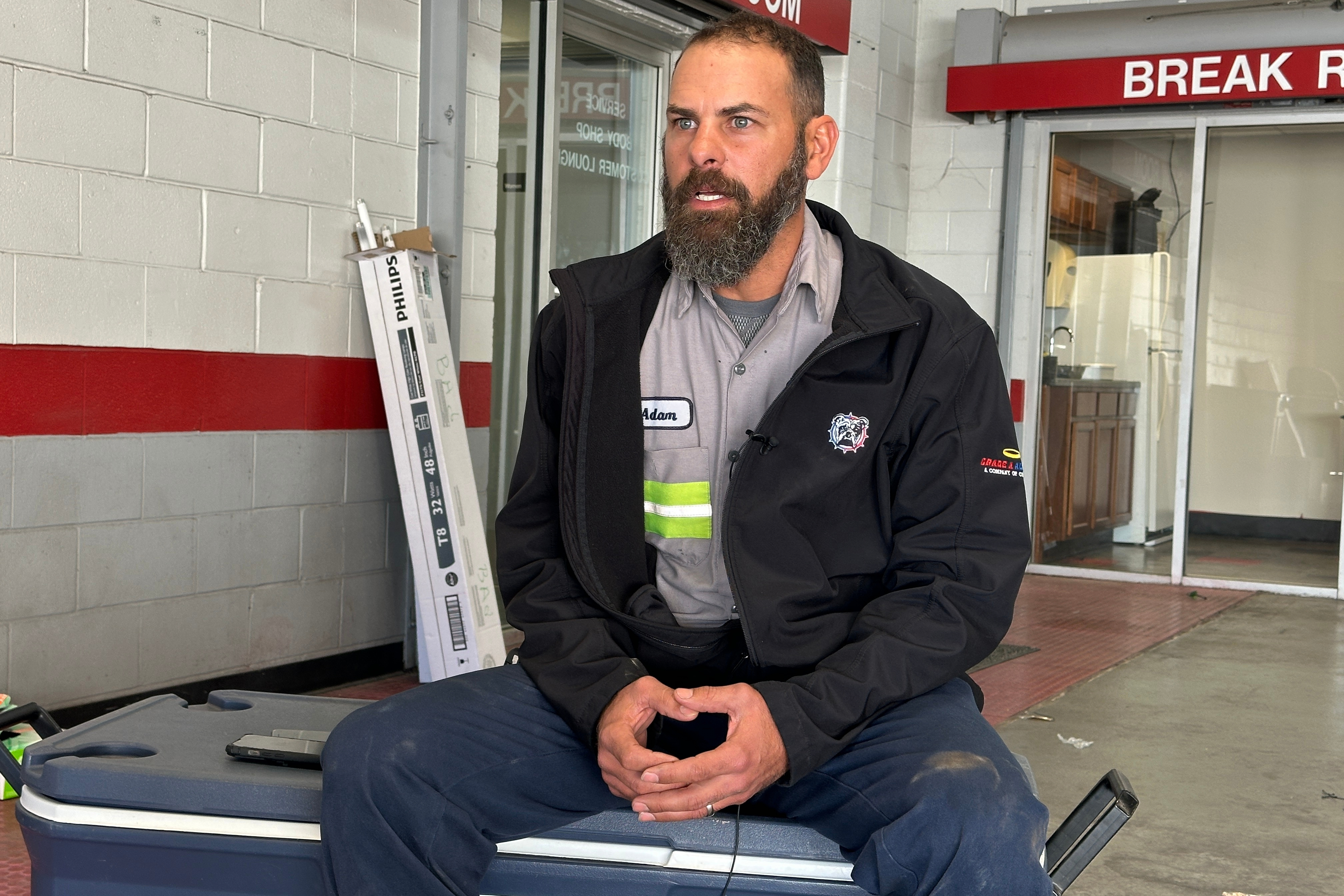 Adam Bowman, a supervisor at Grade A Auto Parts Recycling, is interviewed on Thursday in Louisville, Kentucky, about his actions after the UPS plane crash.