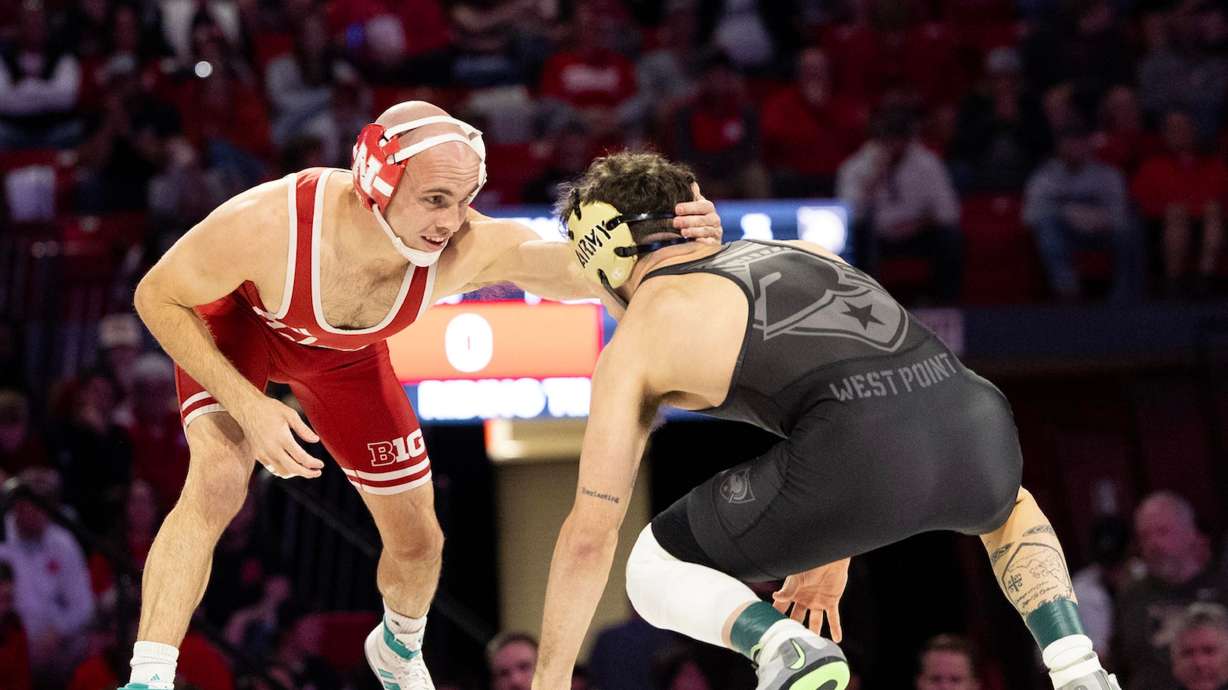 Utah native and Nebraska wrestler Brock Hardy, wearing red singlet, grapples with Wisconsin opponent. Hardy is looking to take his skills to the global stage but wants to take care of business first for Big Red.