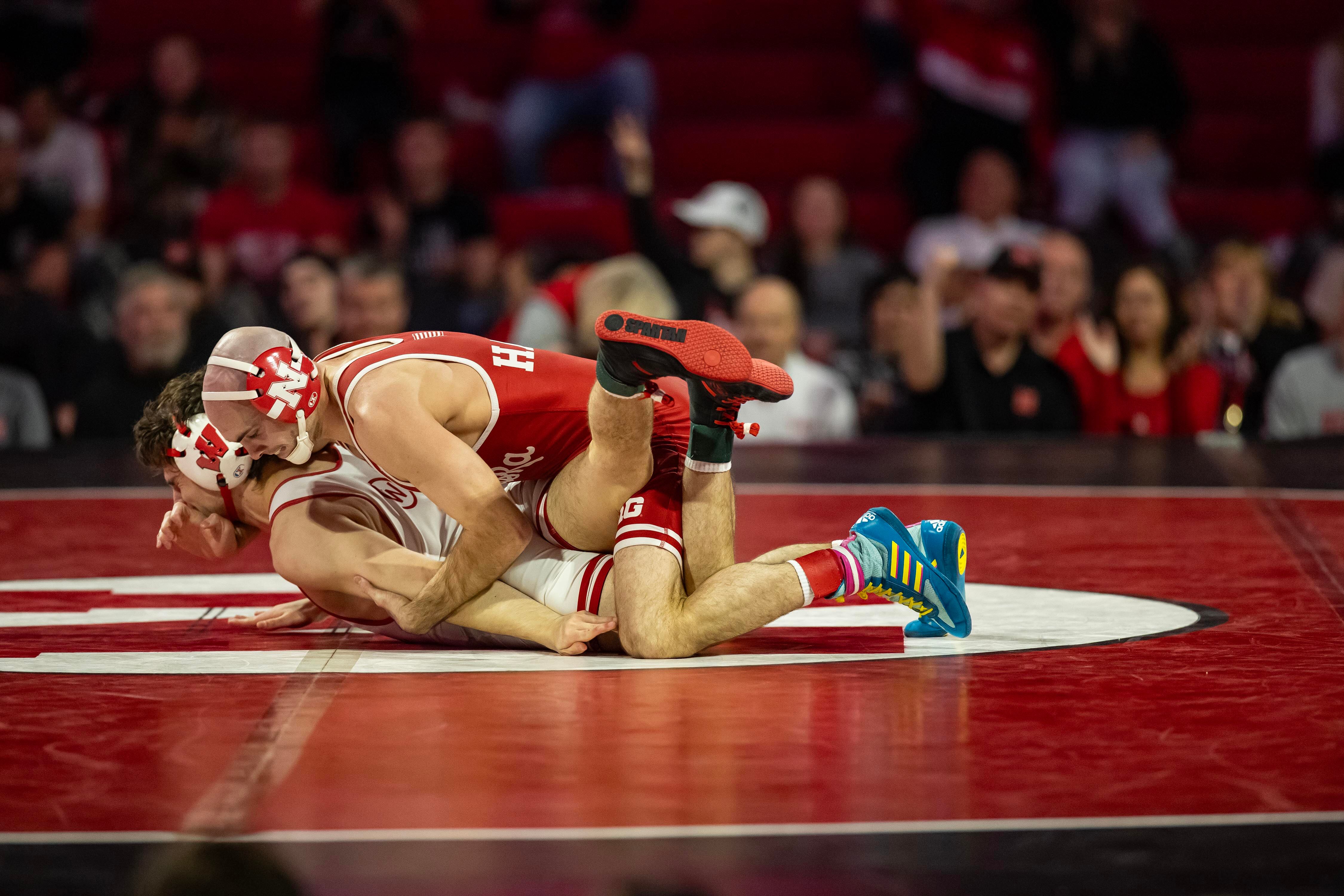 Utah native and Nebraska wrestler Brock Hardy, wearing red singlet, grapples with Wisconsin opponent. Hardy said he expects to have another shot at conference rival Jesse Mendez, whom he lost to in last season's national championship.