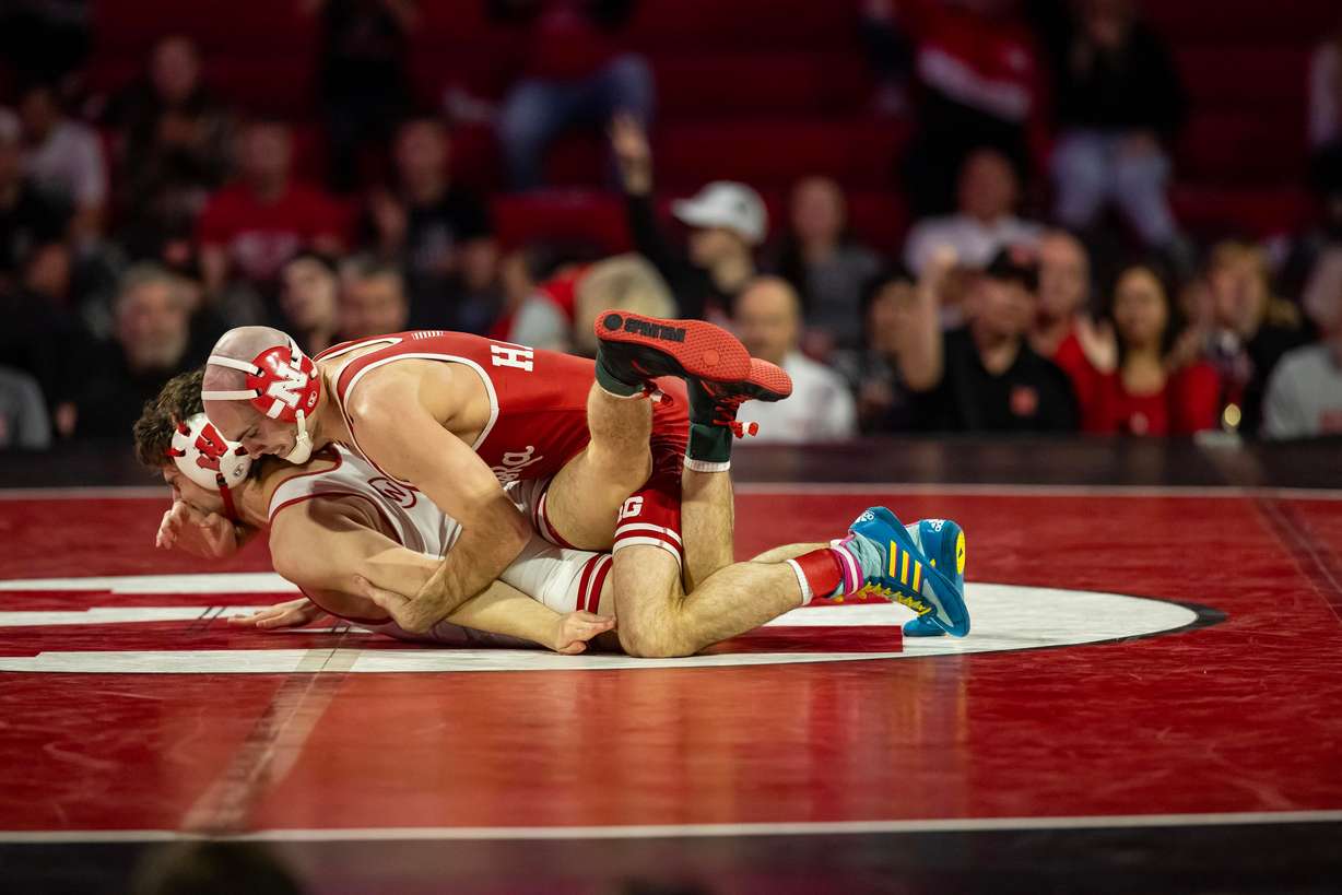 Utah native and Nebraska wrestler Brock Hardy, wearing red singlet, grapples with Wisconsin opponent. Hardy said he expects to have another shot at conference rival Jesse Mendez, whom he lost to in last season's national championship.