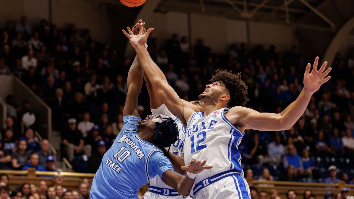 Duke's Cameron Boozer (12) and Indiana State's Enel St. Bernard (10) battle for a rebound during the first half of an NCAA college basketball game in Durham, N.C., Friday, Nov. 14, 2025.