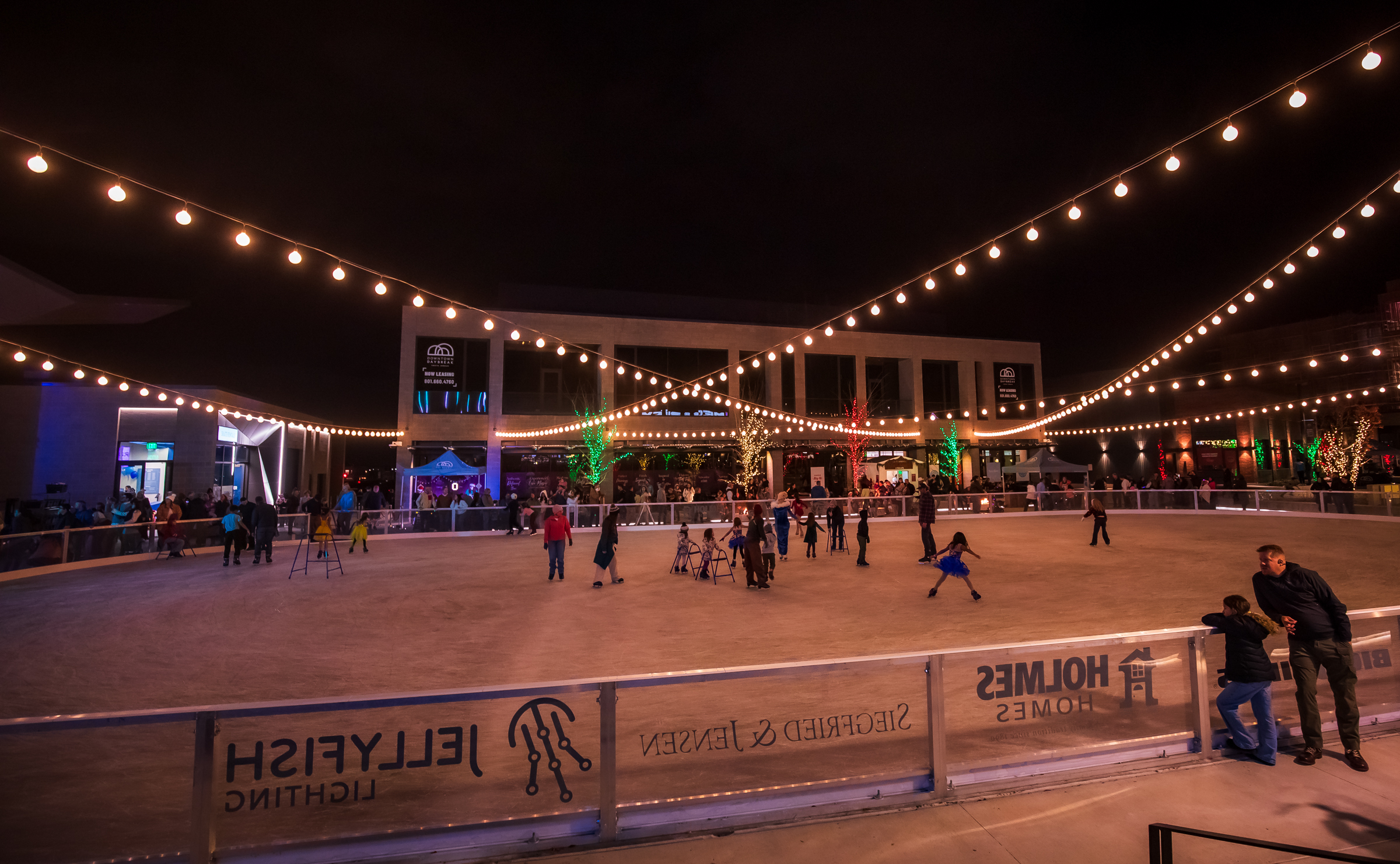 Families skate at the rink at America First Square in South Jordan on Friday.