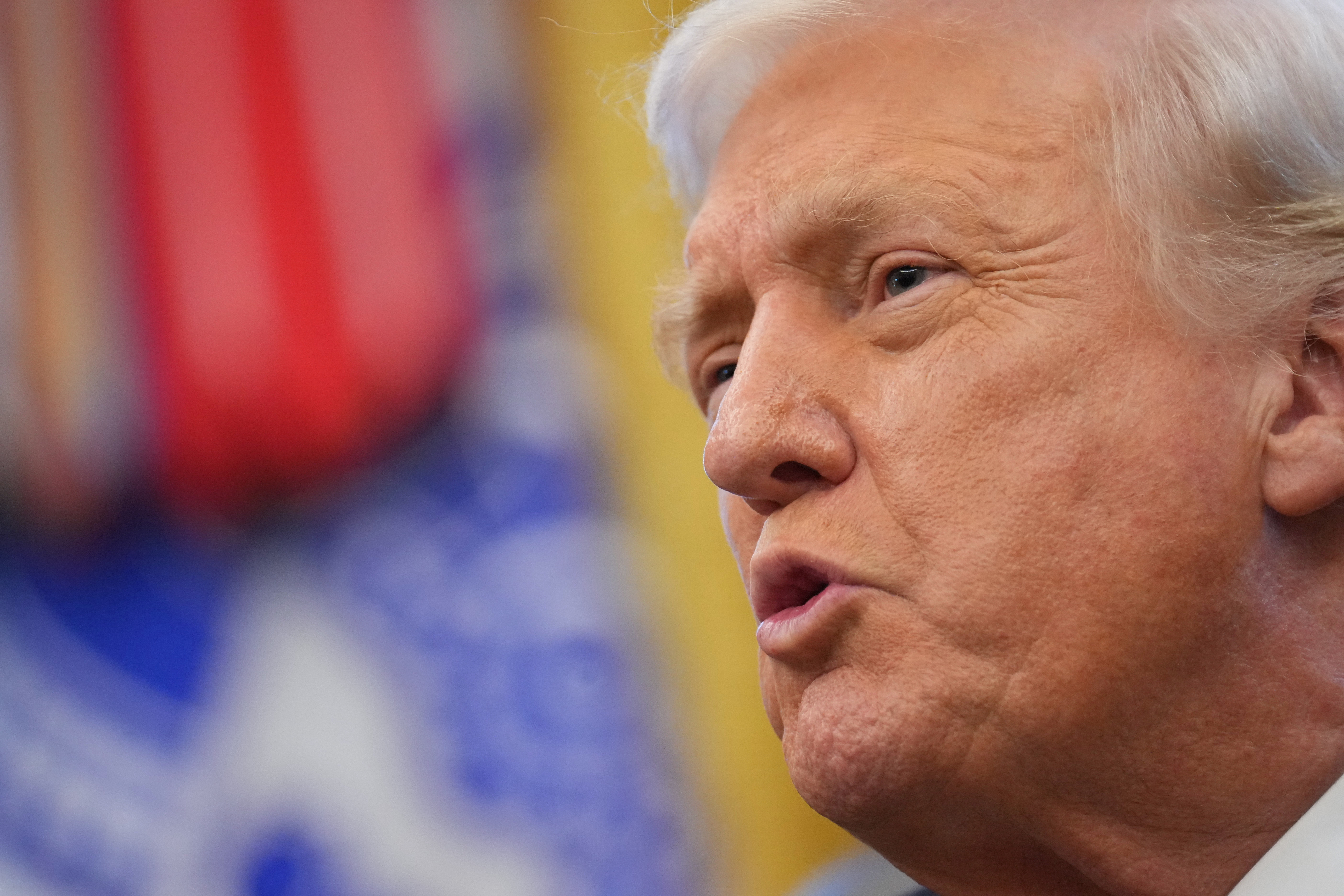 President Donald Trump speaks to reporters in the Oval Office of the White House, Nov. 10, in Washington. In an interview with Fox News host Laura Ingraham, Trump emphasized the need to bring in talent.