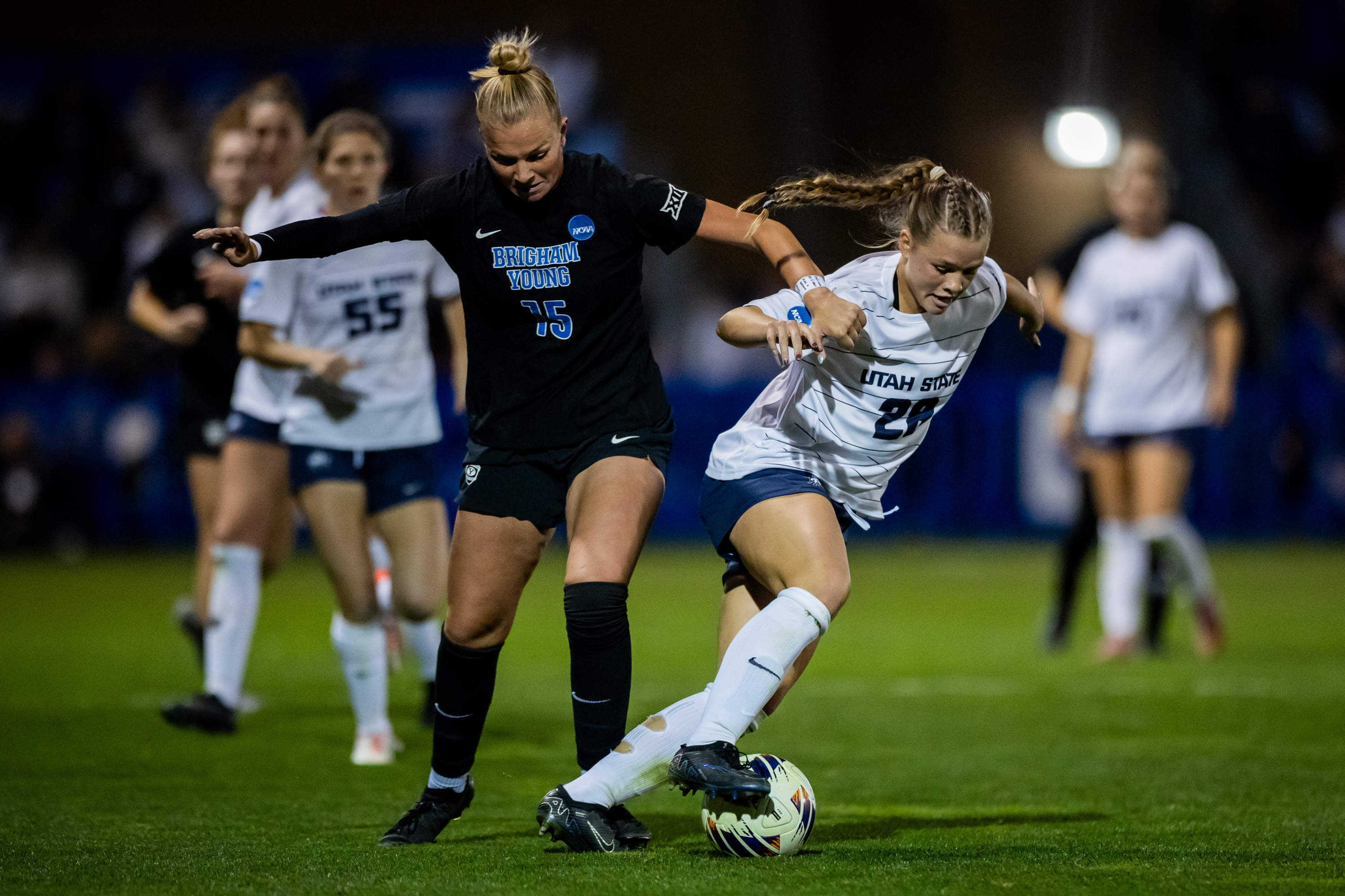 BYU forward/midfielder Ellie Walbruch (15) and Utah State midfielder Kaeda Wilson (28) fight for the ball during an NCAA first-round soccer game at South Field in Provo on Friday, Nov. 14, 2025.