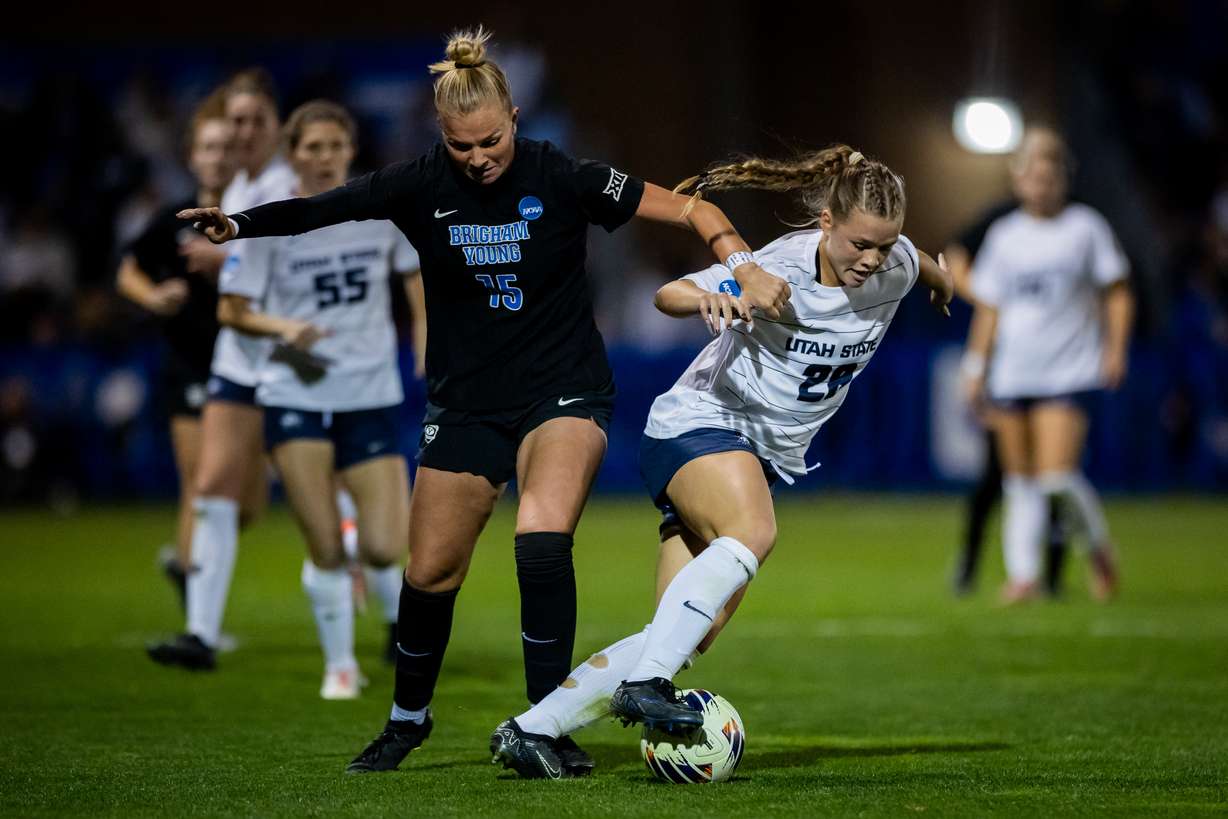 BYU forward/midfielder Ellie Walbruch (15) and Utah State midfielder Kaeda Wilson (28) fight for the ball during an NCAA first-round soccer game at South Field in Provo on Friday, Nov. 14, 2025.