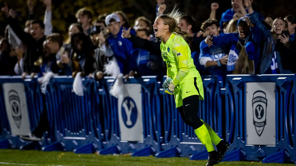 BYU Cougars goalkeeper Chelsea Peterson (00) and BYU Cougars fans celebrate after Peterson won the game for the BYU Cougars after blocking a shot during a penalty kick shootout against the Utah State Aggies in overtime during an NCAA first round soccer game at South Field in Provo on Friday, Nov. 14, 2025.