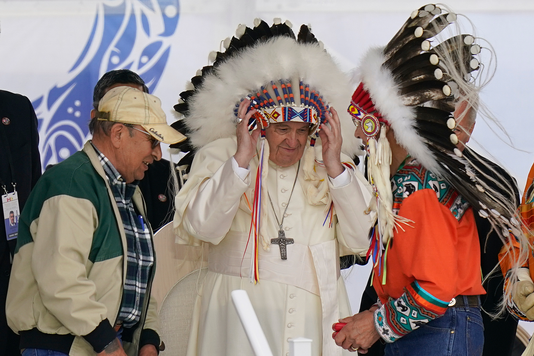 Pope Francis dons a headdress during a visit with Indigenous peoples at Maskwaci, the former Ermineskin Residential School, July 25, 2022, in Maskwacis, Alberta, Canada. The Vatican returned 62 more artifacts to Indigneous peoples in Canada Saturday.