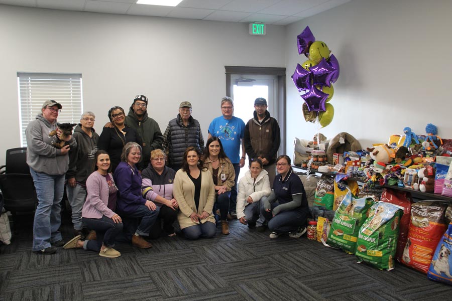 Alex Alvarez and Maggie Bradley stand with representatives of animal welfare organizations and Enhabit staff. The parents created a pet supplies donation drive in honor of their late daughter.