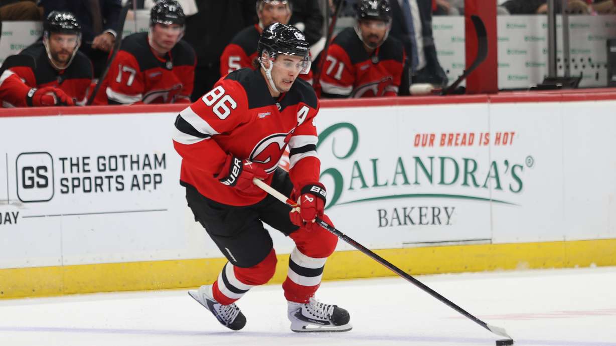 New Jersey Devils' Jack Hughes skates with the puck during the second period of an NHL hockey game against the Colorado Avalanche, Sunday, Oct. 26, 2025, in Newark, N.J.