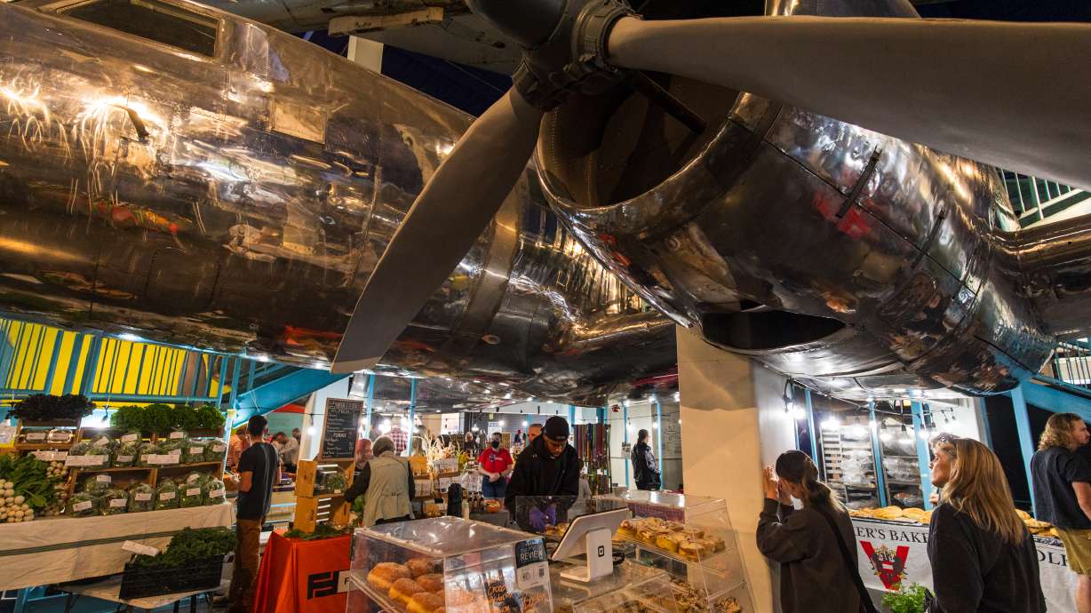 Eats Bakery underneath a C-131 military transport plane at The Leonardo in Salt Lake City on Nov. 15, 2025. The plane was recently scrapped, while another historic plane is in the process of being scrapped, Salt Lake City officials said.