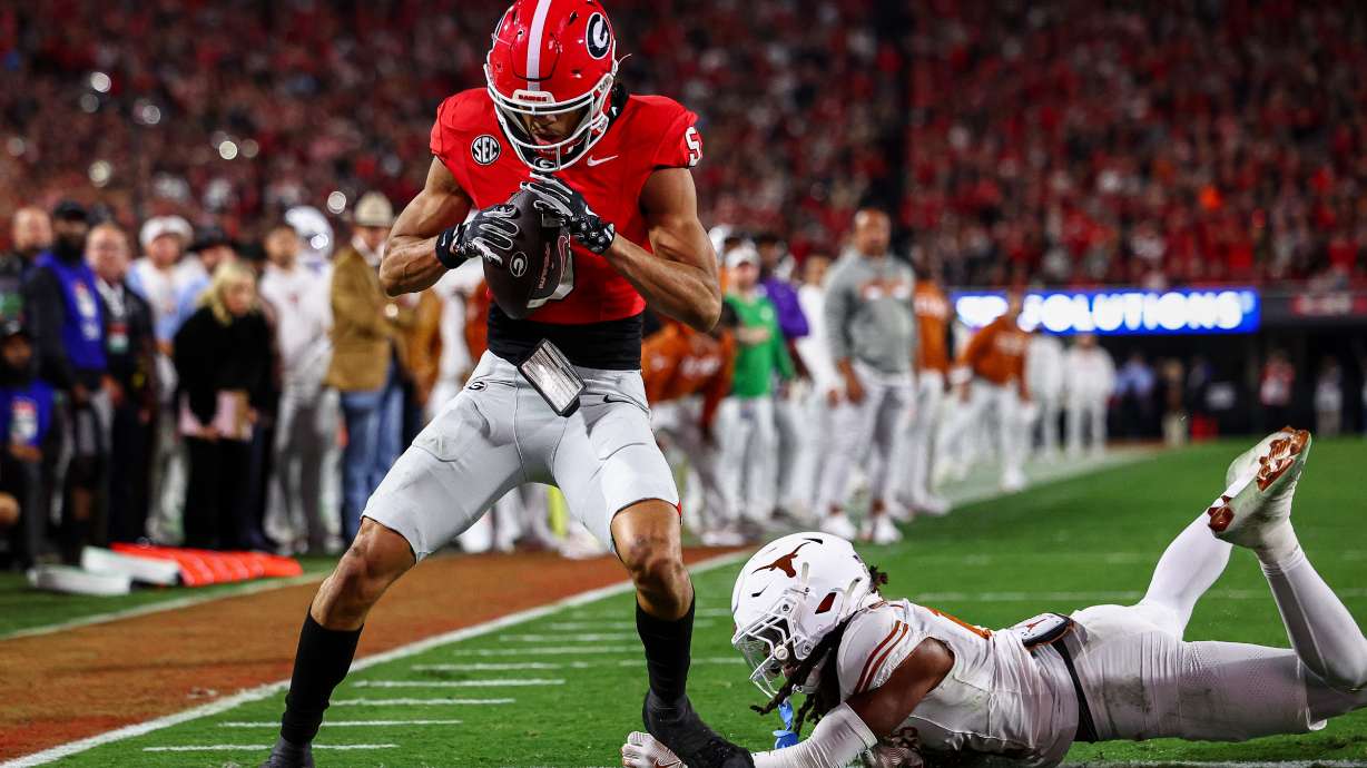 Georgia wide receiver Noah Thomas (5) scores a touchdown past Texas defensive back Kade Phillips (11) during the first half of an NCAA college football game, Saturday, Nov. 15, 2025, in Athens, Ga.