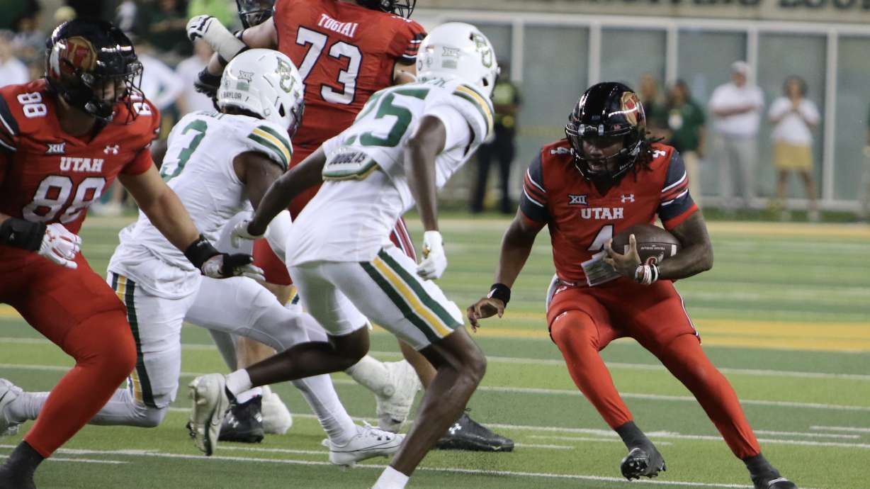 Utah quarterback Devon Dampier attempts to elude Baylor defenders at McLane Stadium in Waco, Texas, on Nov. 15, 2025.