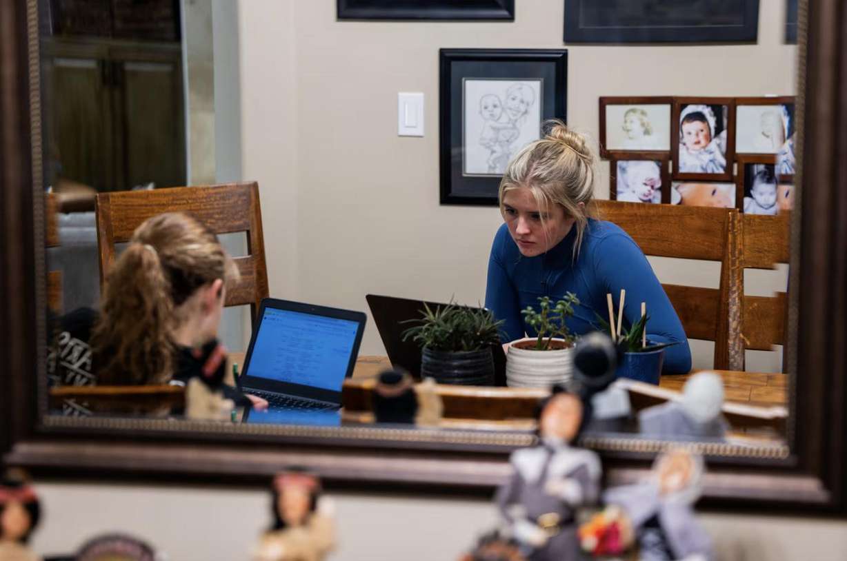 Caroline Long, 13, left, and sister Becca Long, 17, do work for school at their home in Bountiful on Nov. 6.