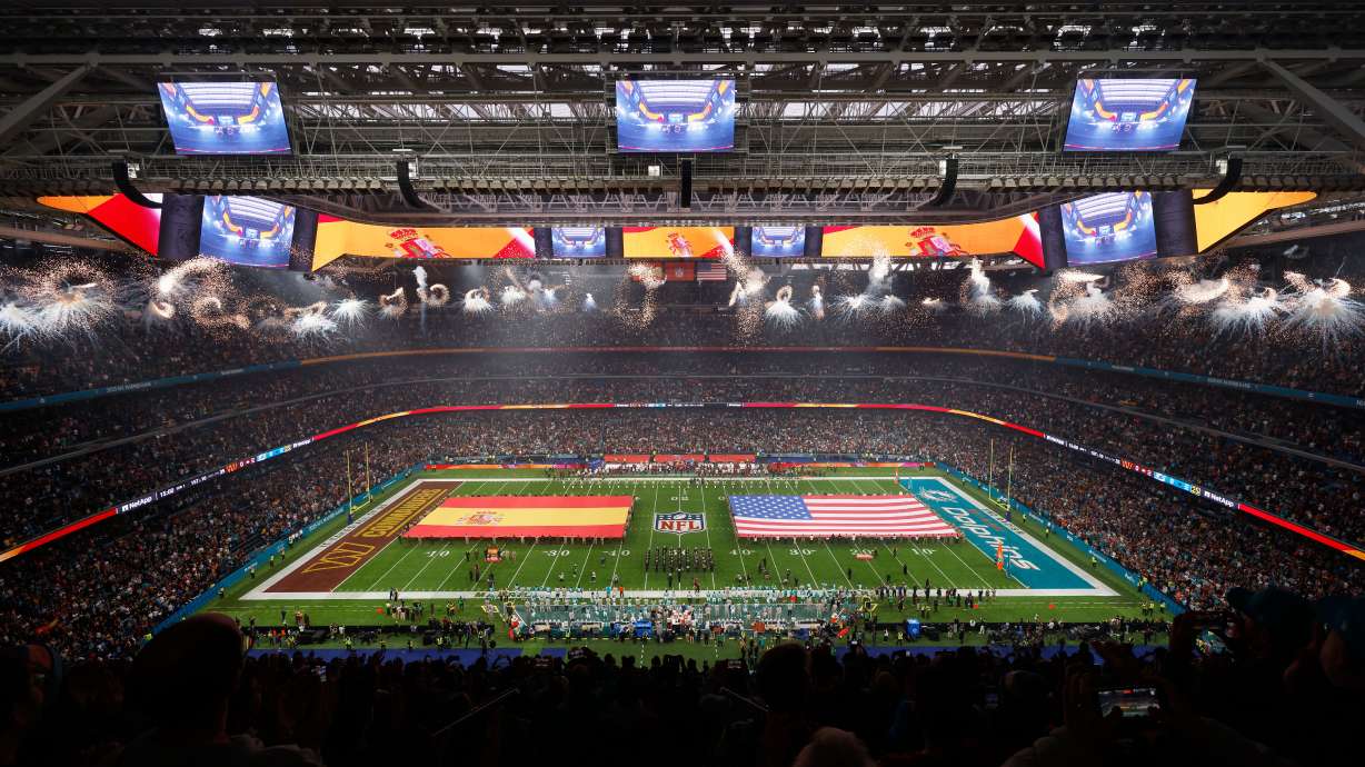 An overall, interior, general view of the Santiango Bernabeu stadium during the singing of the national anthems before an NFL football game between the Miami Dolphins and the Washington Commanders in Madrid, Spain, Sunday, Nov. 16, 2025.