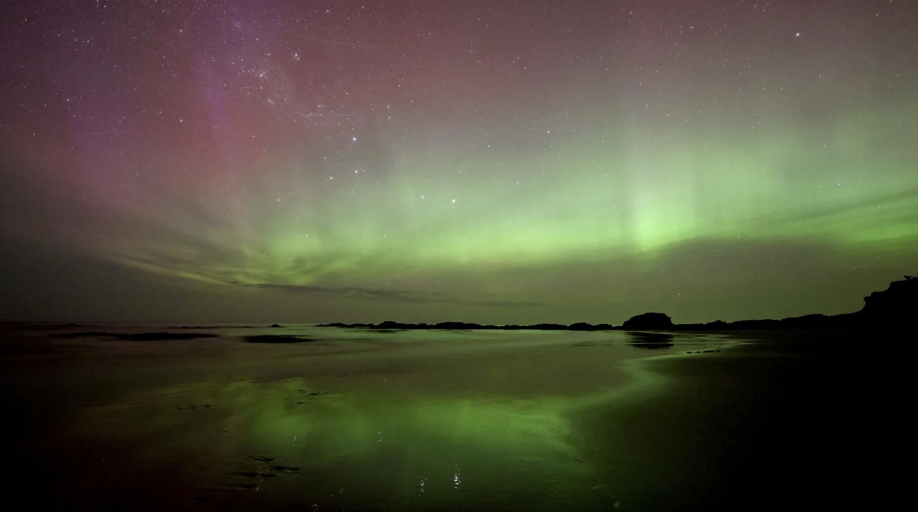 The aurora australis, also known as the southern lights, glowed over the waters of Brighton Beach in Dunedin, New Zealand, on Tuesday.
