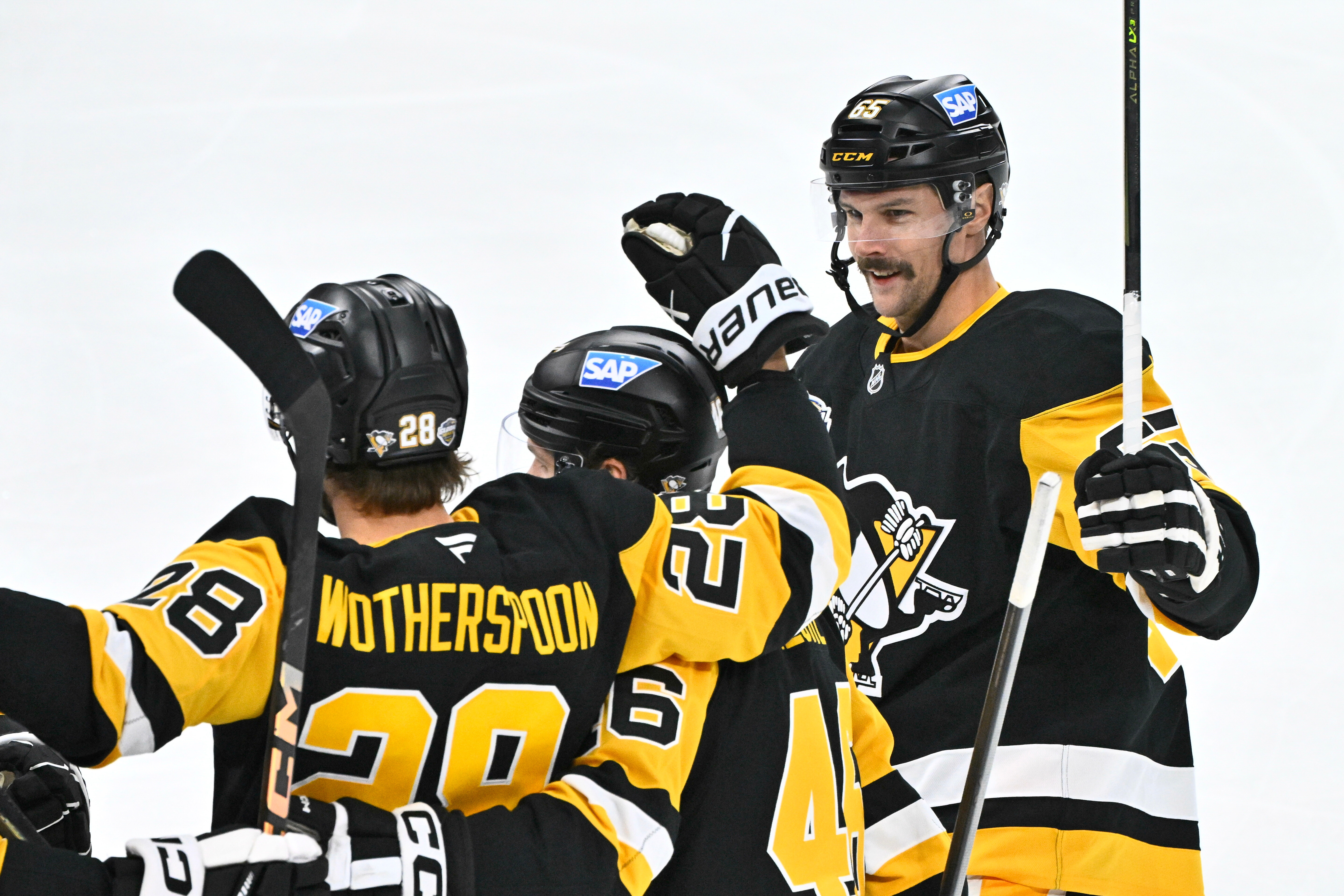 Pittsburgh's Parker Wotherspoon is congratulated by teammates Blake Lizotte and Erik Karlsson after his 1-0 goal during the NHL Global Series hockey game between the Pittsburgh Penguins and the Nashville Predators in Stockholm, Sweden, Sunday, Nov. 16, 2025.